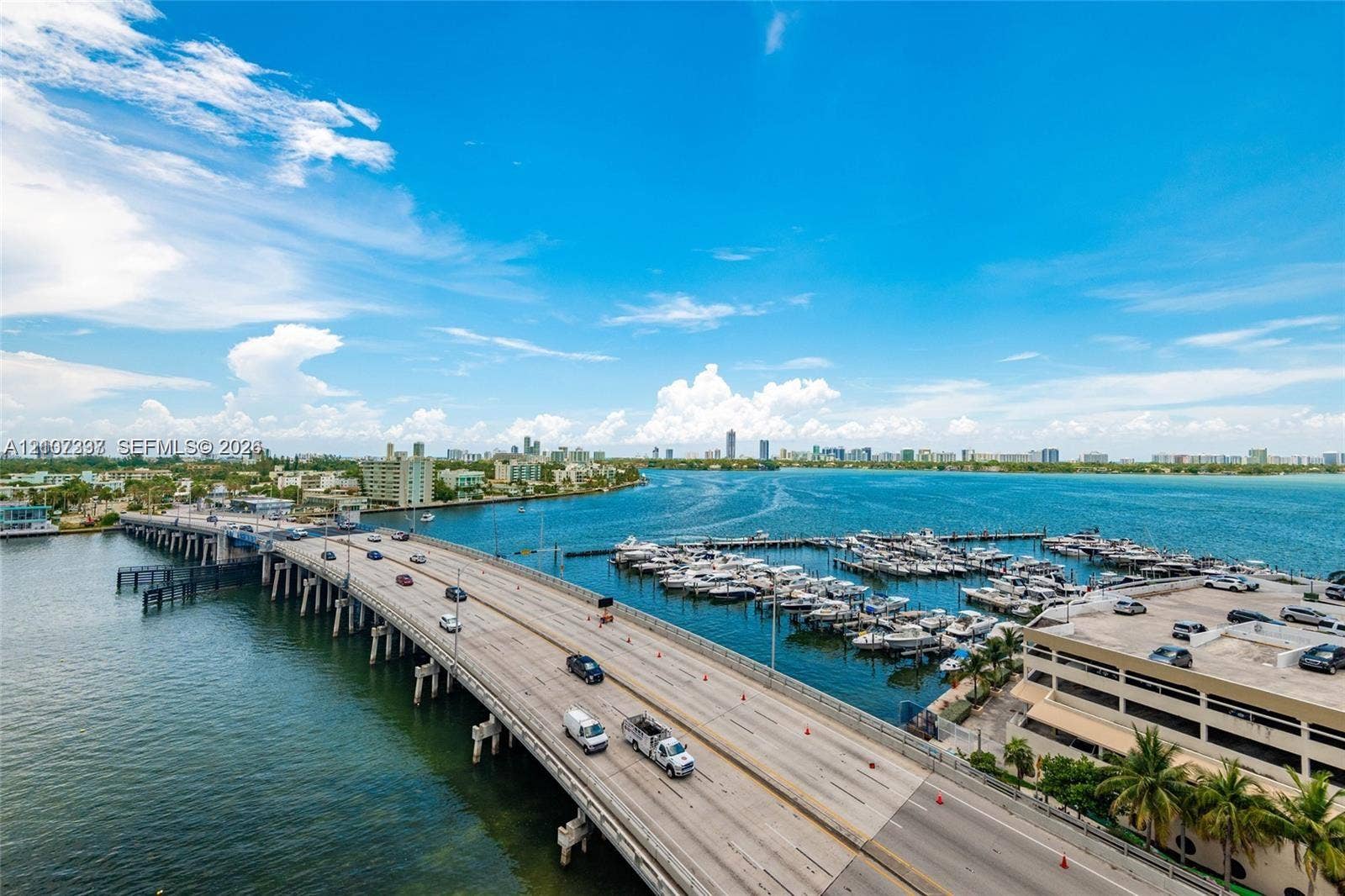 1881 79th St Causeway, #1007, North Bay Village, FL 33141 Aerial perspective overlooking a multi-slip marina, expansive waterway, and coastal bridge infrastructure