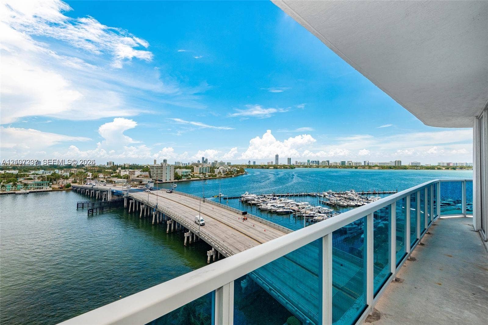 1881 79th St Causeway, #1007, North Bay Village, FL 33141 Covered balcony featuring concrete flooring and a blue-tinted glass railing
