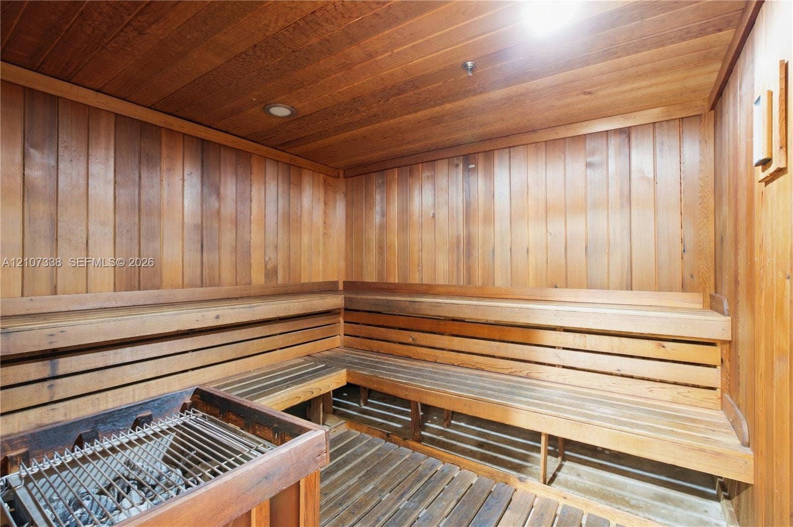 20355 NE 34th Court, #1824, Aventura, FL 33180 Sauna featuring natural wood tongue-and-groove wall paneling, tiered bench seating, slatted floorboards, and a built-in heating element