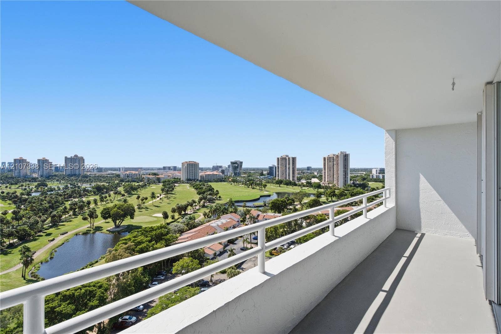 20355 NE 34th Court, #1824, Aventura, FL 33180 Covered balcony with white metal railings, concrete flooring, and unobstructed exterior exposure