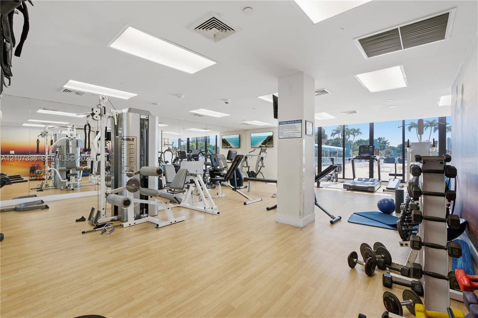 20355 NE 34th Court, #1824, Aventura, FL 33180 Fitness center featuring wood-finish flooring, full-length wall mirrors, recessed lighting, and floor-to-ceiling windows