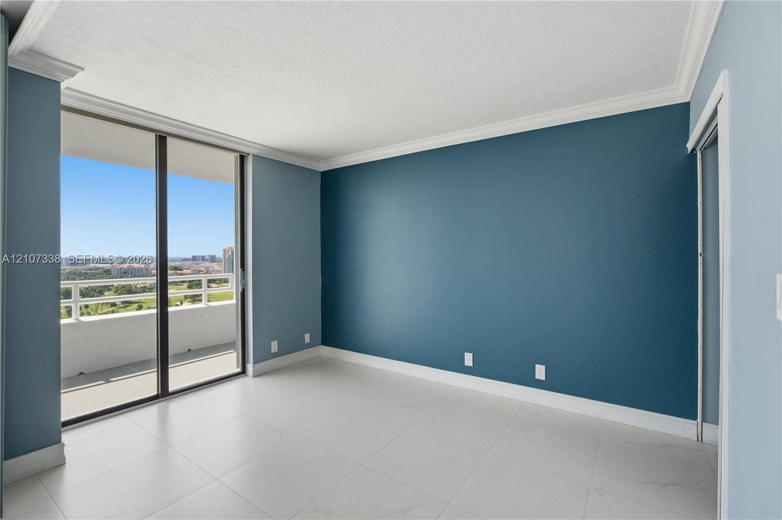20355 NE 34th Court, #1824, Aventura, FL 33180 Floor-to-ceiling sliding glass doors, private balcony, large-format tile flooring, and crown molding