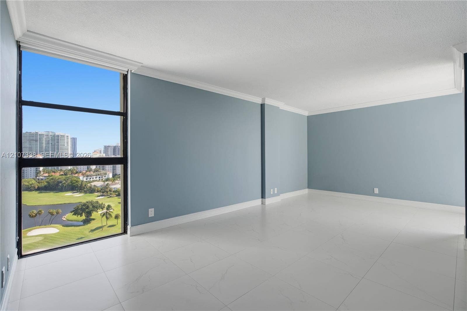 20355 NE 34th Court, #1824, Aventura, FL 33180 Floor-to-ceiling windows, large-format tile flooring, crown molding, and neutral wall tones