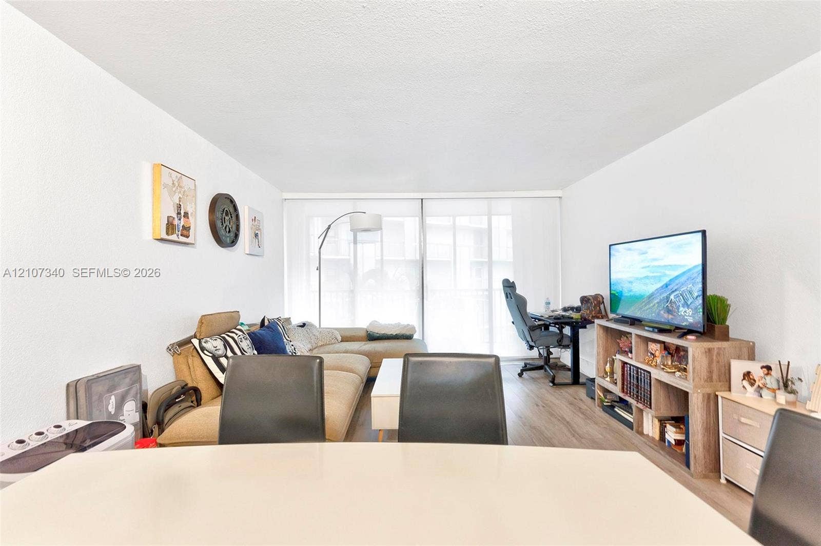 3401 N Country Club Drive, #406, Aventura, Aventura, FL 33180 Open-concept living space featuring wood-finish flooring and a floor-to-ceiling sliding glass door
