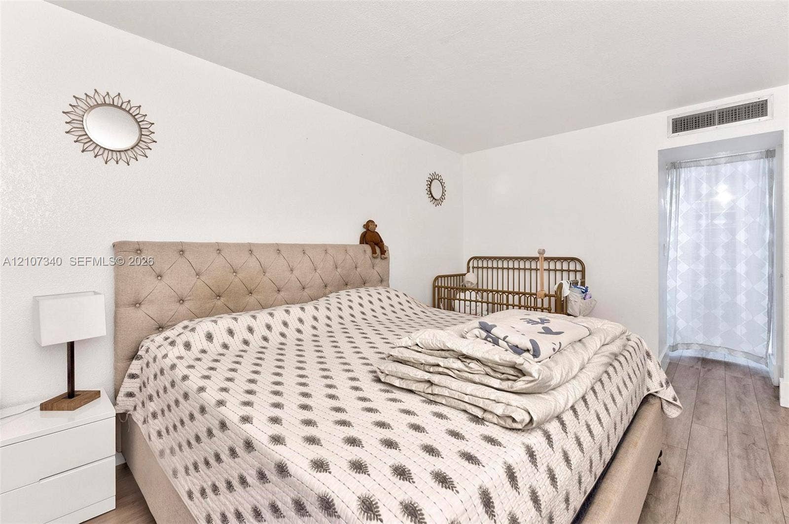 3401 N Country Club Drive, #406, Aventura, Aventura, FL 33180 Room featuring wood-finish flooring, smooth-finish white walls, and a tall arched doorway