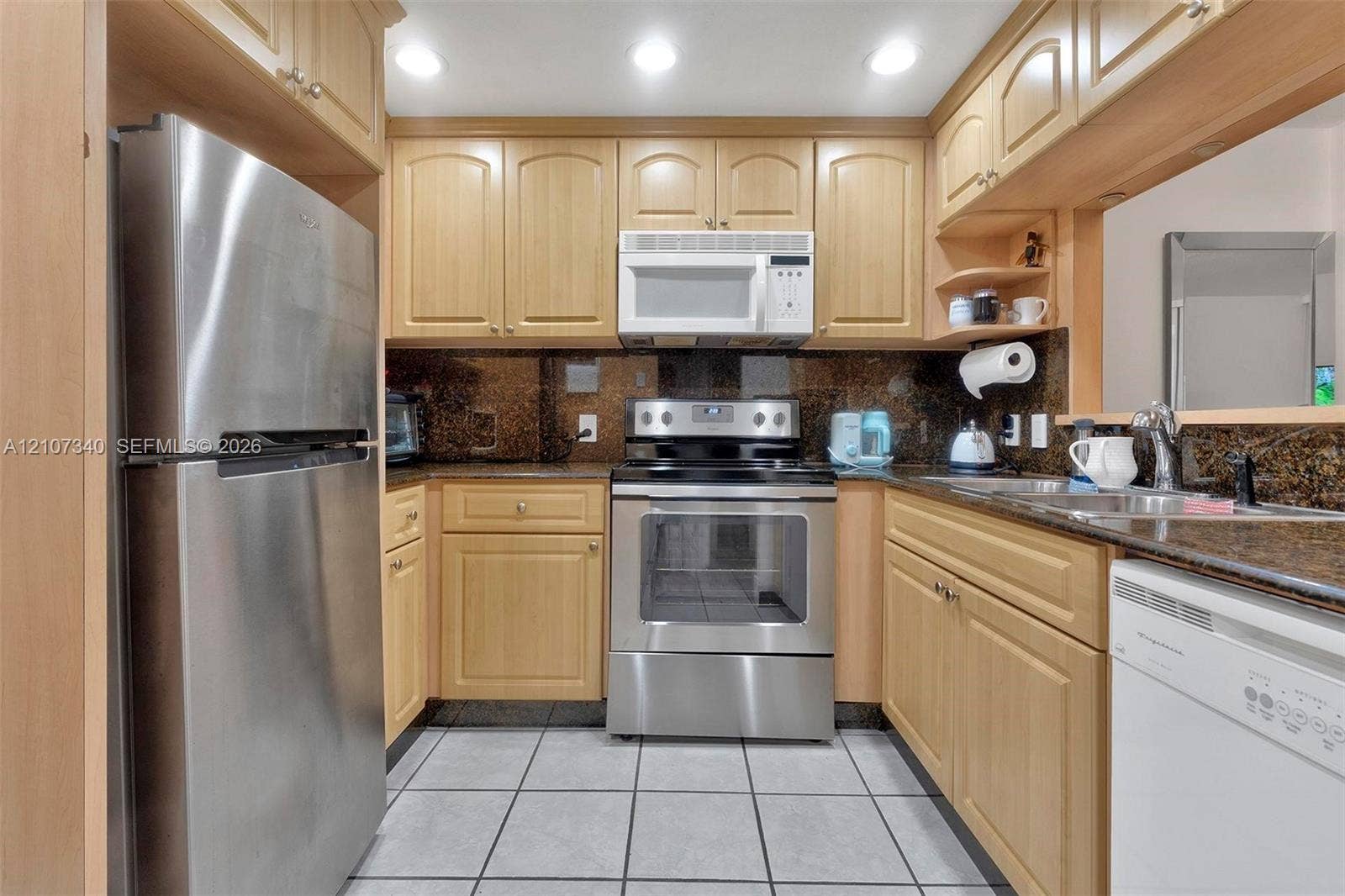 3401 N Country Club Drive, #406, Aventura, Aventura, FL 33180 Kitchen featuring light-finish wood cabinetry, stone countertops, stainless steel appliances, recessed ceiling lighting, and tiled flooring