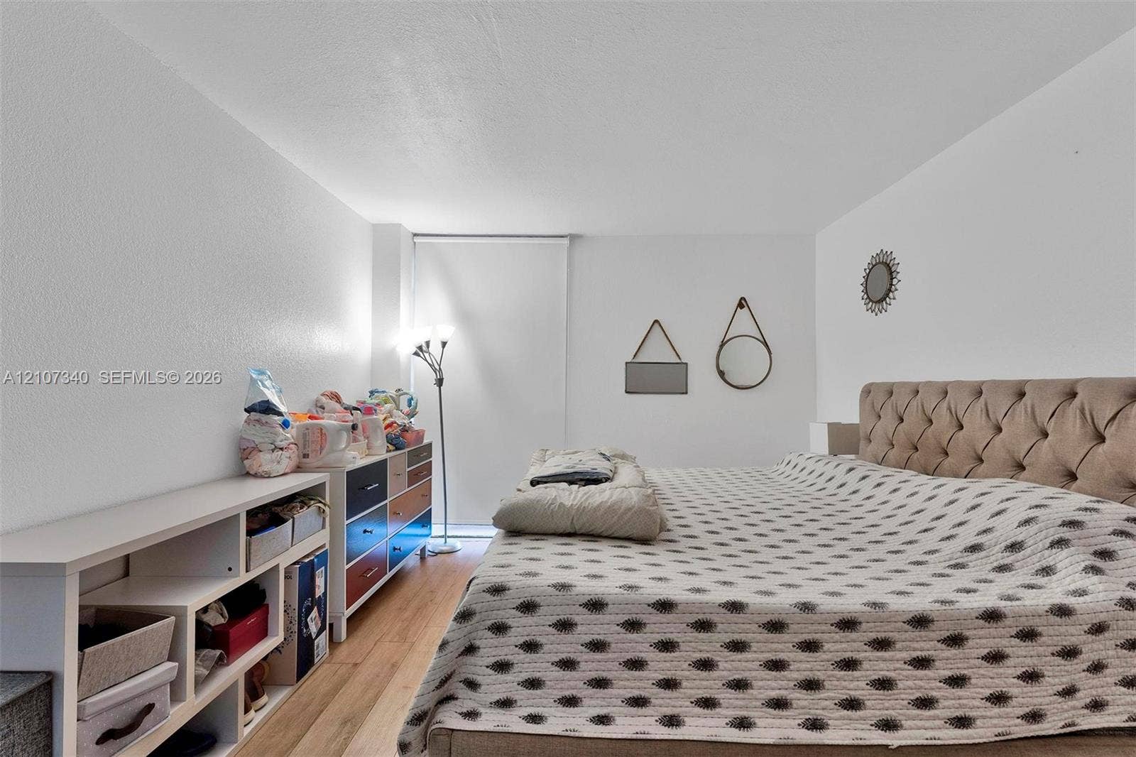3401 N Country Club Drive, #406, Aventura, Aventura, FL 33180 Neutral wall finishes, wood-finish flooring, and a large window featuring a retractable privacy shade