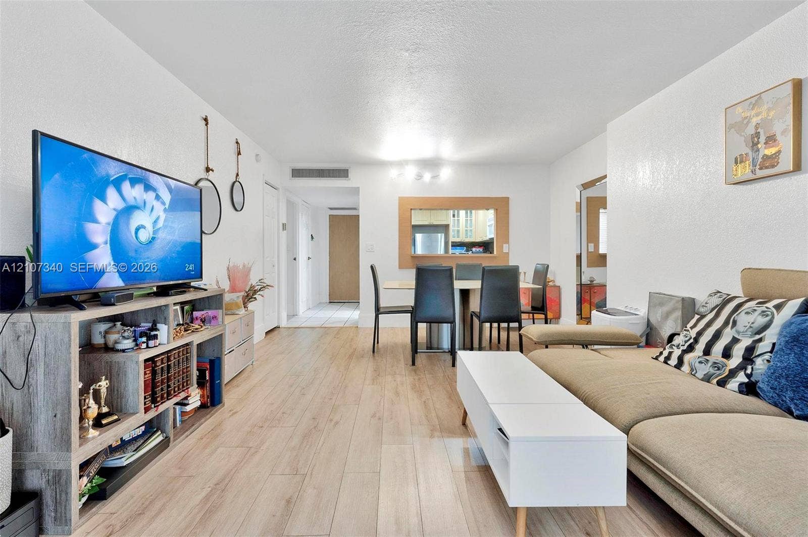 3401 N Country Club Drive, #406, Aventura, Aventura, FL 33180 Interior space featuring wood-finish flooring, smooth-textured walls, and a recessed pass-through window with wooden trim