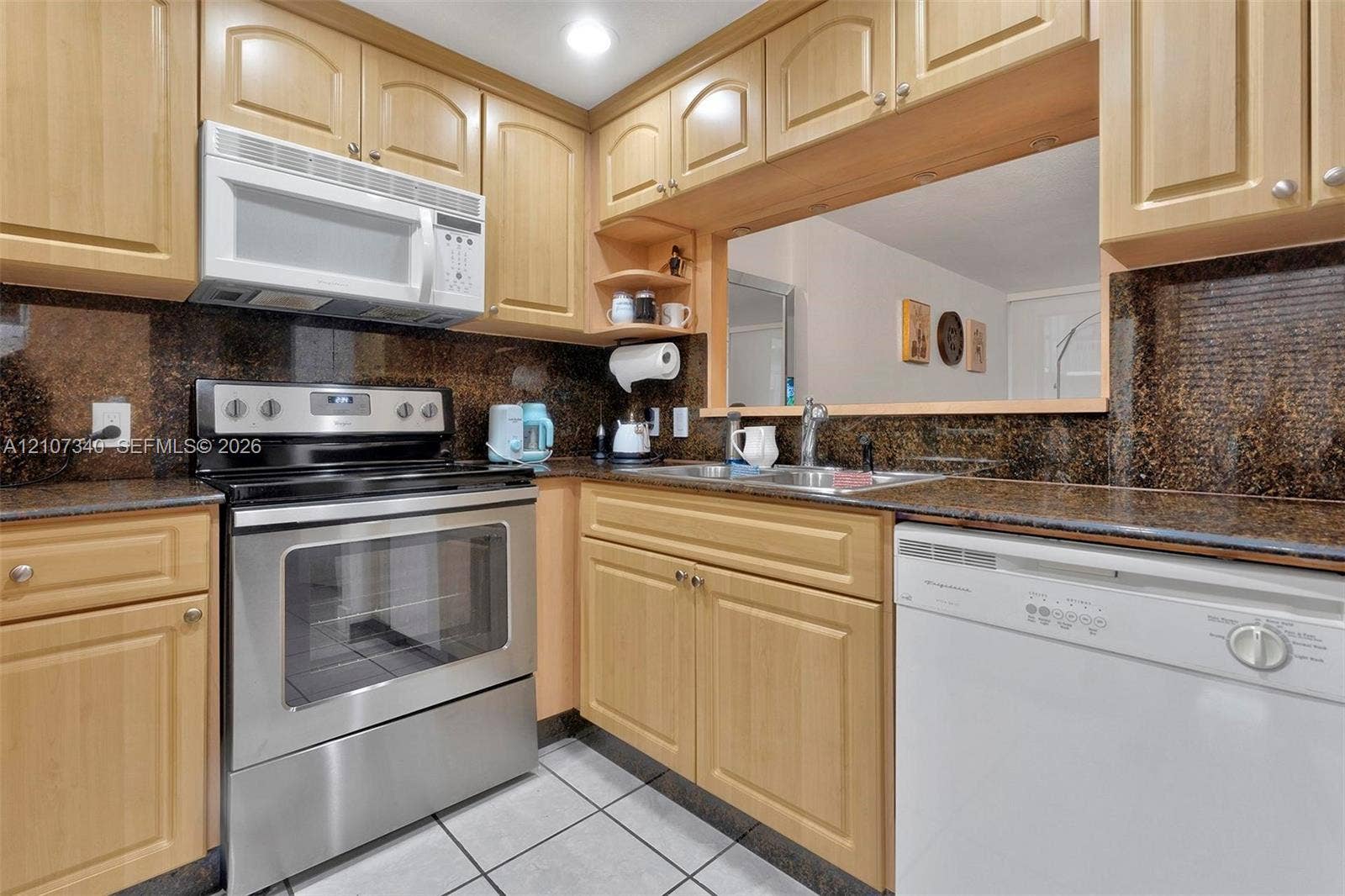 3401 N Country Club Drive, #406, Aventura, Aventura, FL 33180 Kitchen featuring natural wood cabinetry, stone-surface countertops, stainless steel electric range, over-the-range microwave, and tile flooring