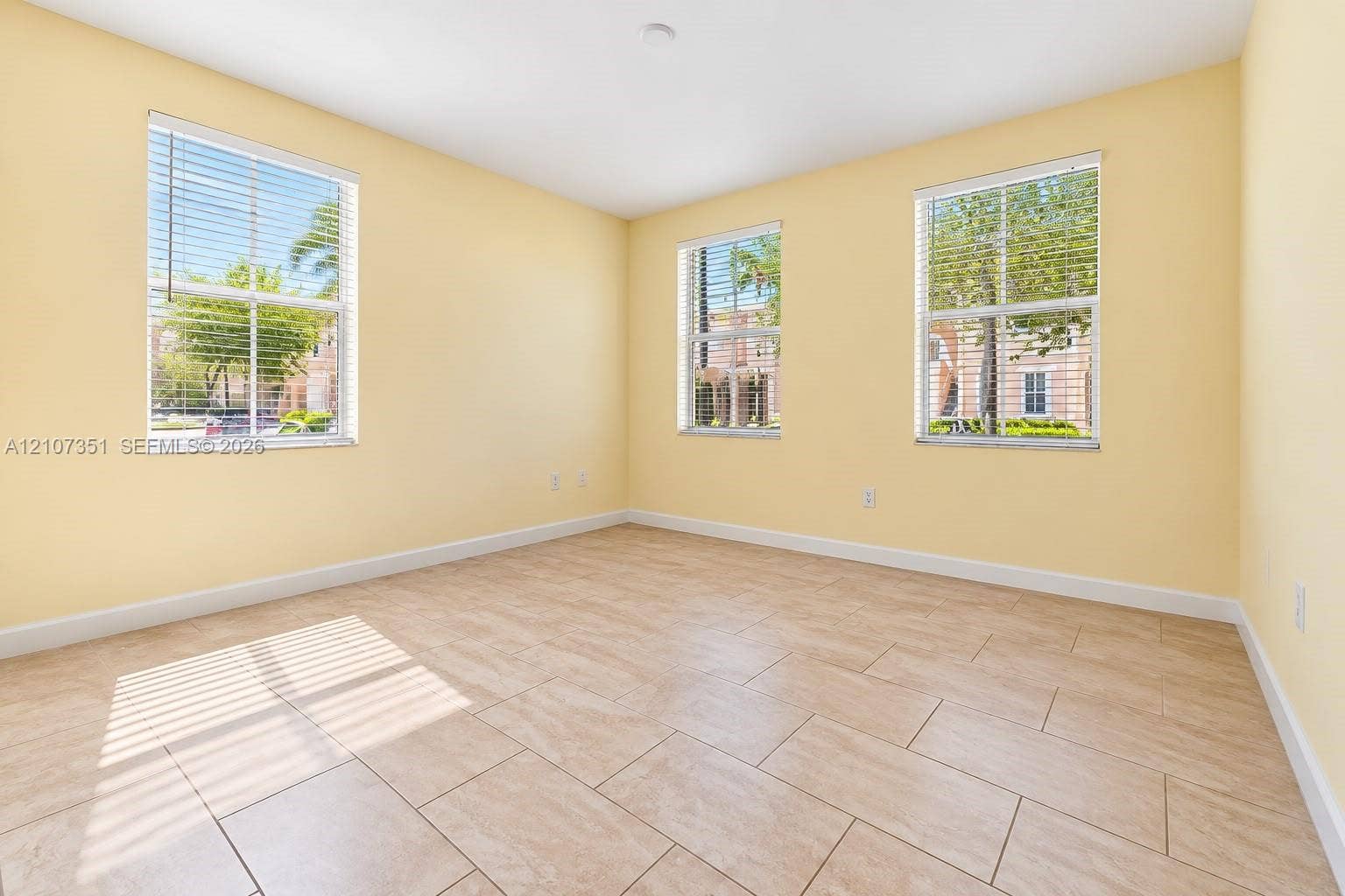 230 SE 29th Avenue, #1, Homestead, Homestead, FL 33033 Room featuring tile flooring and three windows with built-in horizontal blinds