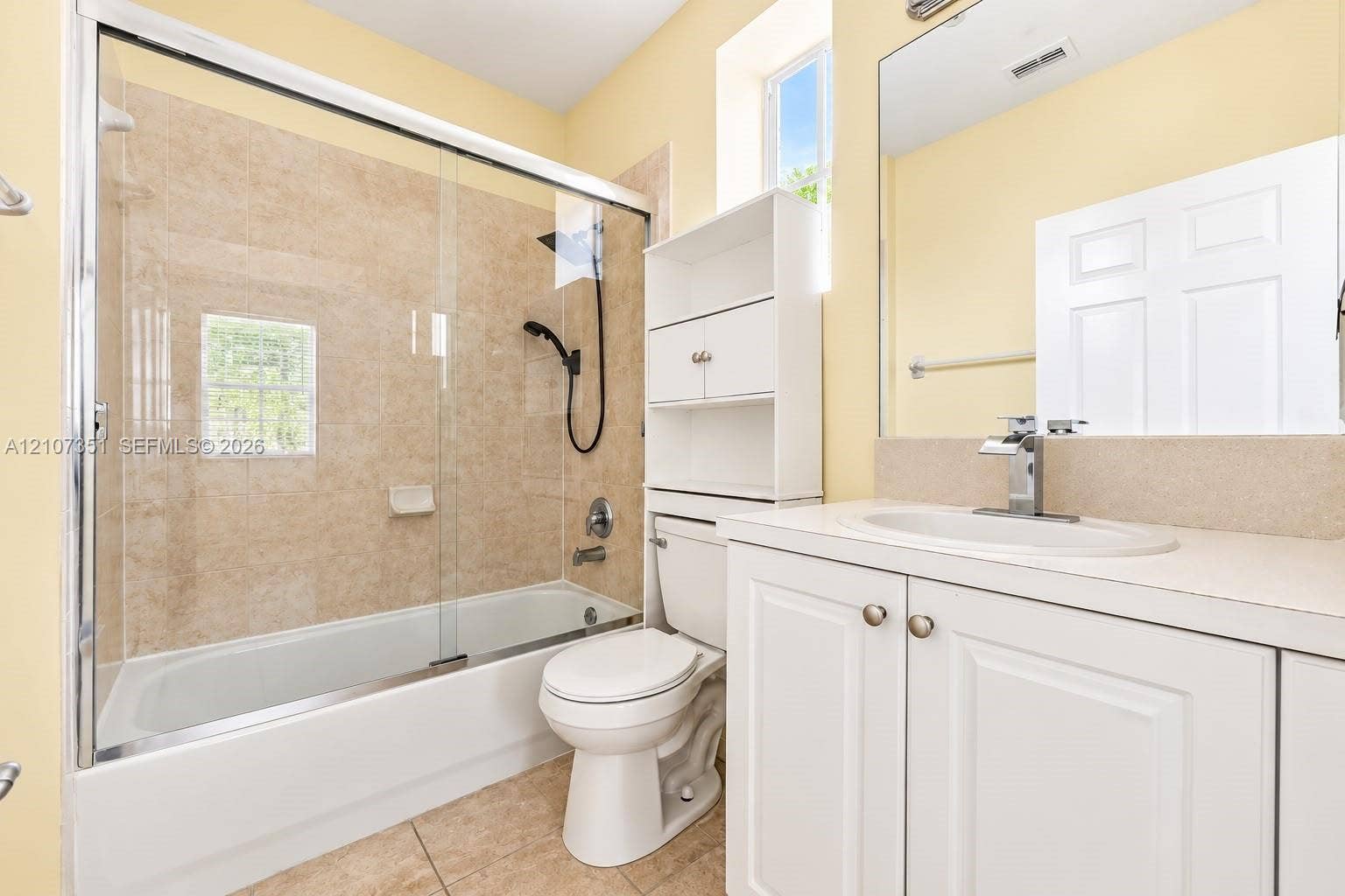 230 SE 29th Avenue, #1, Homestead, Homestead, FL 33033 Bathroom featuring a white vanity with an integrated sink, polished chrome faucet, glass-enclosed tub-shower combination with neutral tile surround, and tile flooring