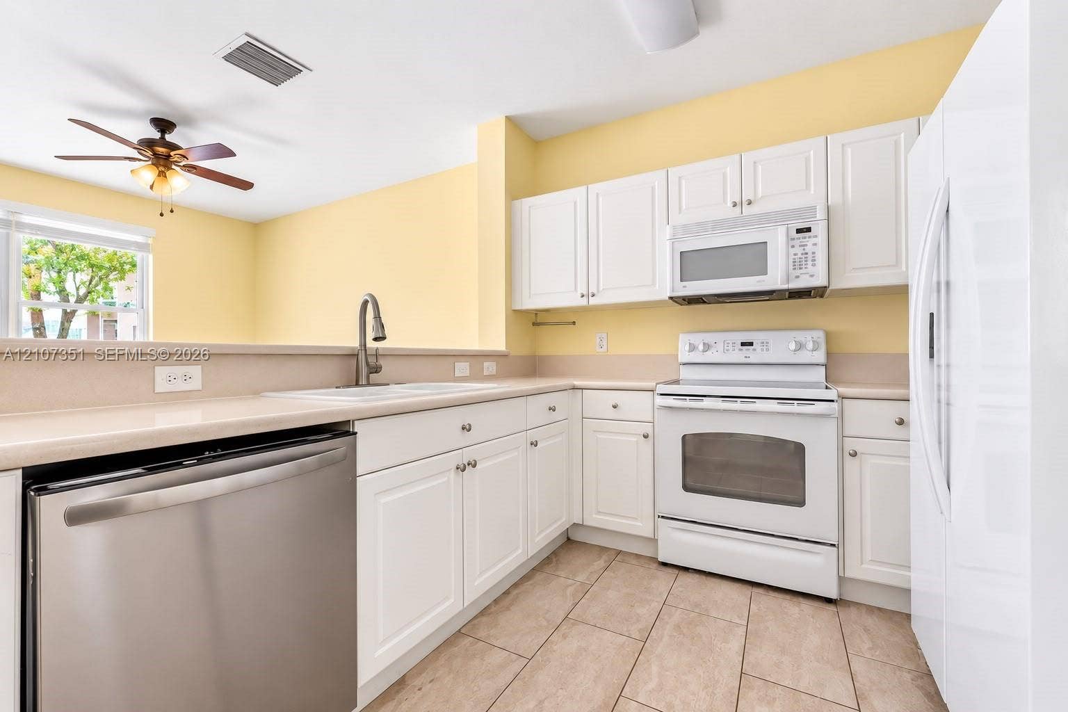230 SE 29th Avenue, #1, Homestead, Homestead, FL 33033 Kitchen featuring white cabinetry, solid-surface countertops, tile flooring, stainless steel dishwasher, and a ceiling fan