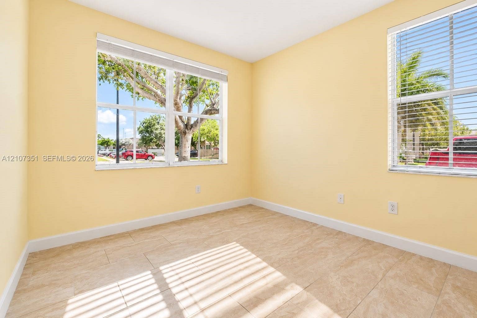 230 SE 29th Avenue, #1, Homestead, Homestead, FL 33033 Interior room featuring tile flooring, neutral wall paint, and dual windows equipped with horizontal blinds