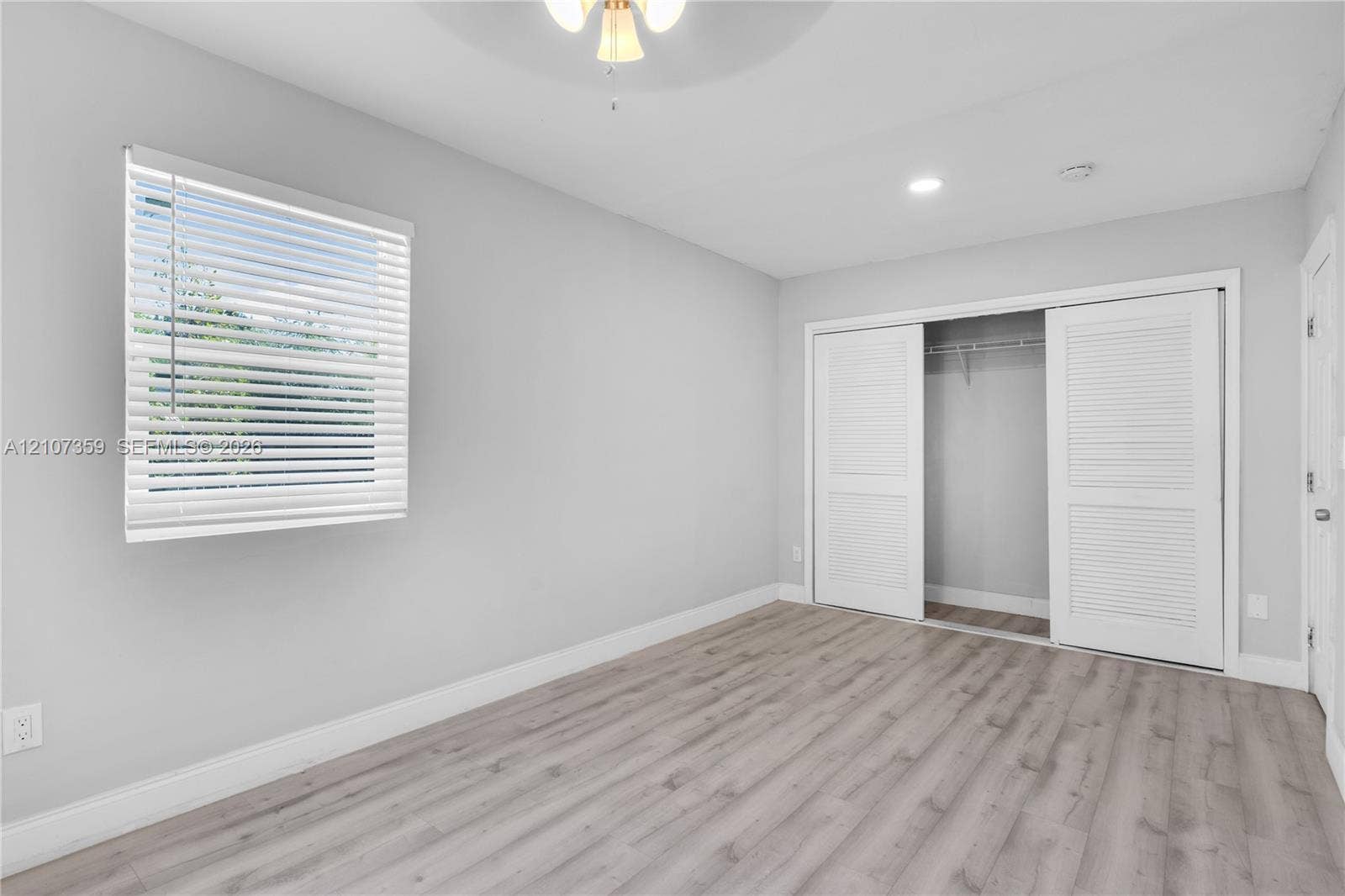 4500 NE 18th Avenue, Pompano Beach, Pompano Beach, FL 33064 Bedroom with wood-look flooring, natural light, and neutral finishes.