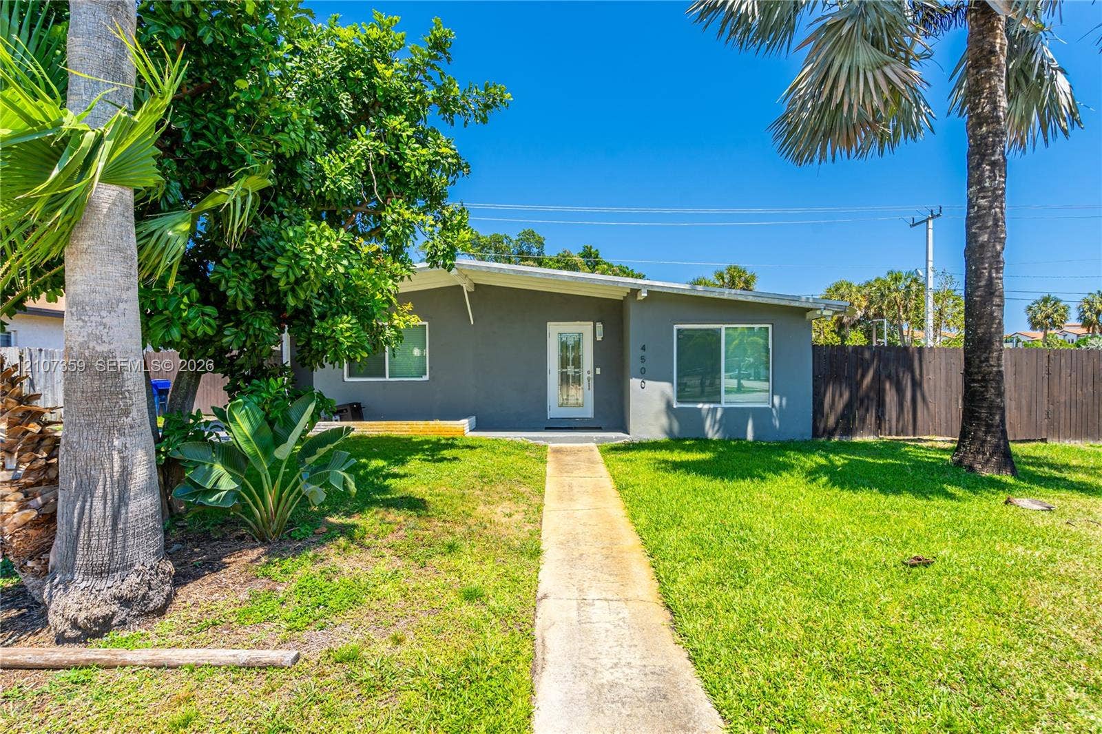 4500 NE 18th Avenue, Pompano Beach, Pompano Beach, FL 33064 Additional exterior view highlighting the home and surrounding yard