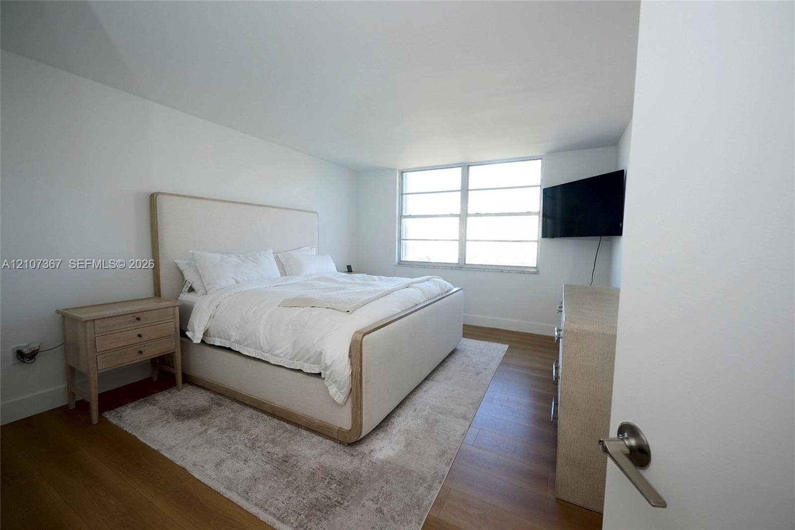 2851 NE 183rd Street, #1617E, Aventura, FL 33160 Interior space featuring wood-finish flooring and expansive windows with horizontal window panes