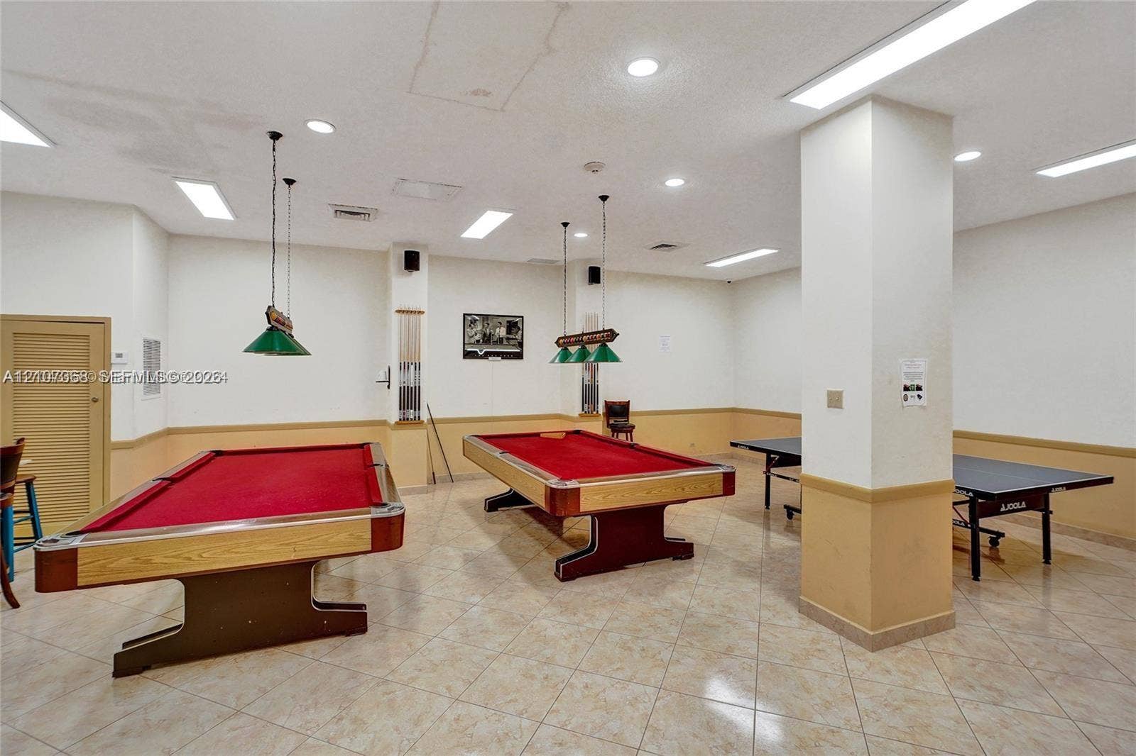 251 174th Street, #415, Sunny Isles Beach, FL 33160 Large recreation room featuring tile flooring, neutral wall coloring with wainscoting, recessed lighting, and dual billiard light fixtures