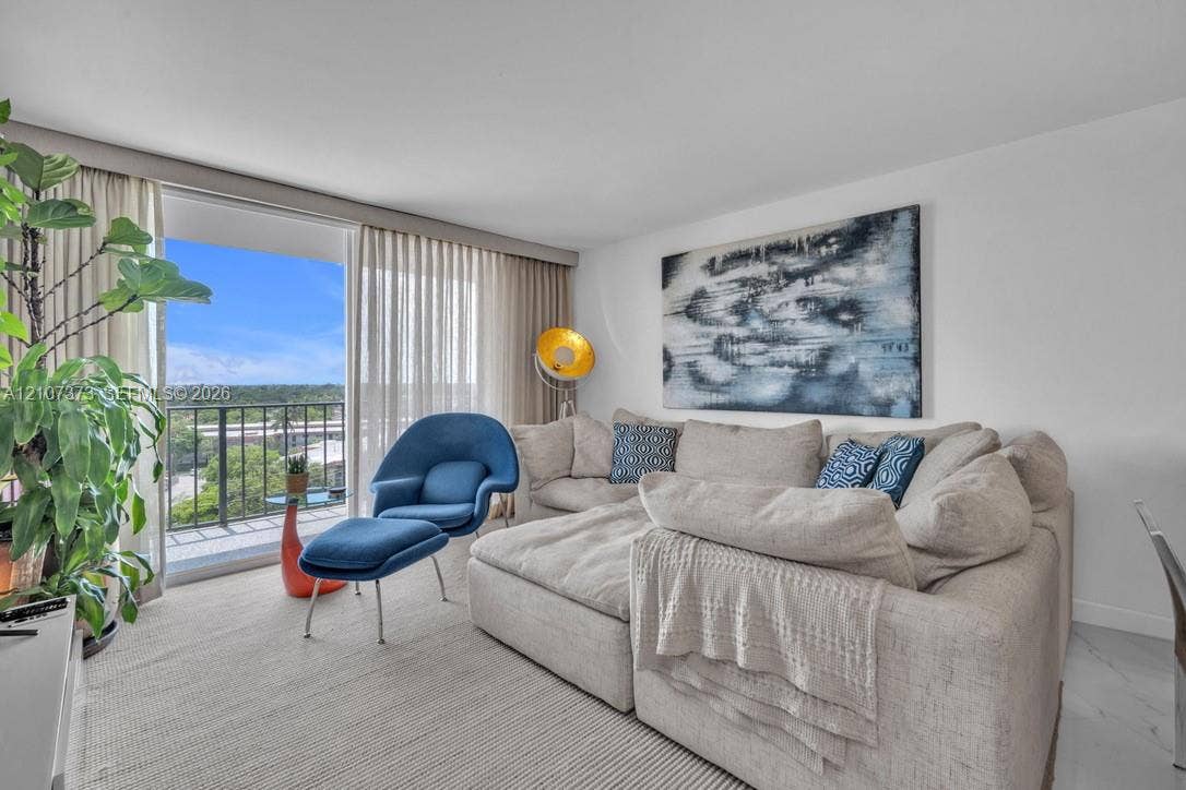 1800 N Andrews Avenue, #9K, Fort Lauderdale, Fort Lauderdale, FL 33311 Sliding glass door opening to a private balcony with metal railing, floor-to-ceiling drapery, and large-format tile flooring