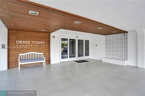 1800 N Andrews Avenue, #9K, Fort Lauderdale, Fort Lauderdale, FL 33311 Covered entryway featuring wood-finish ceiling paneling, large-format tile flooring, recessed lighting, and decorative architectural screen wall
