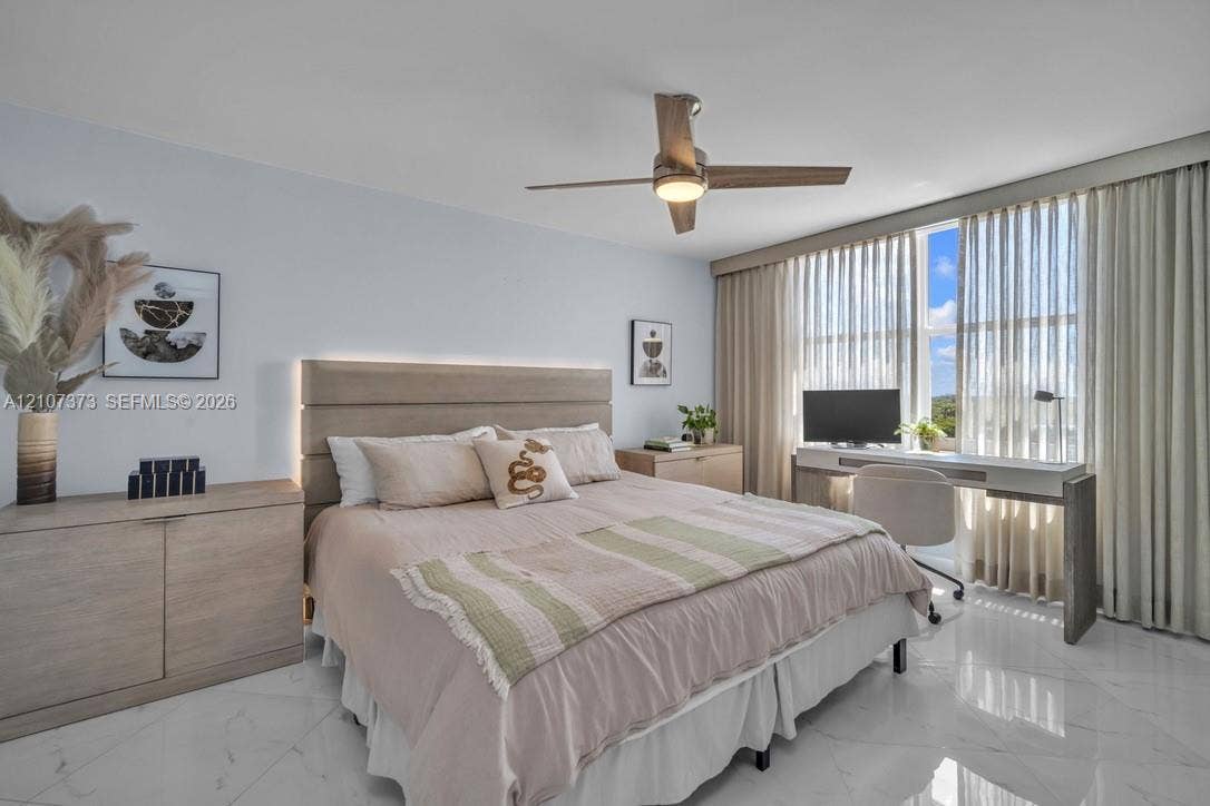 1800 N Andrews Avenue, #9K, Fort Lauderdale, Fort Lauderdale, FL 33311 Polished stone flooring, custom integrated headboard with perimeter lighting, ceiling fan with light fixture, and floor-to-ceiling drapery