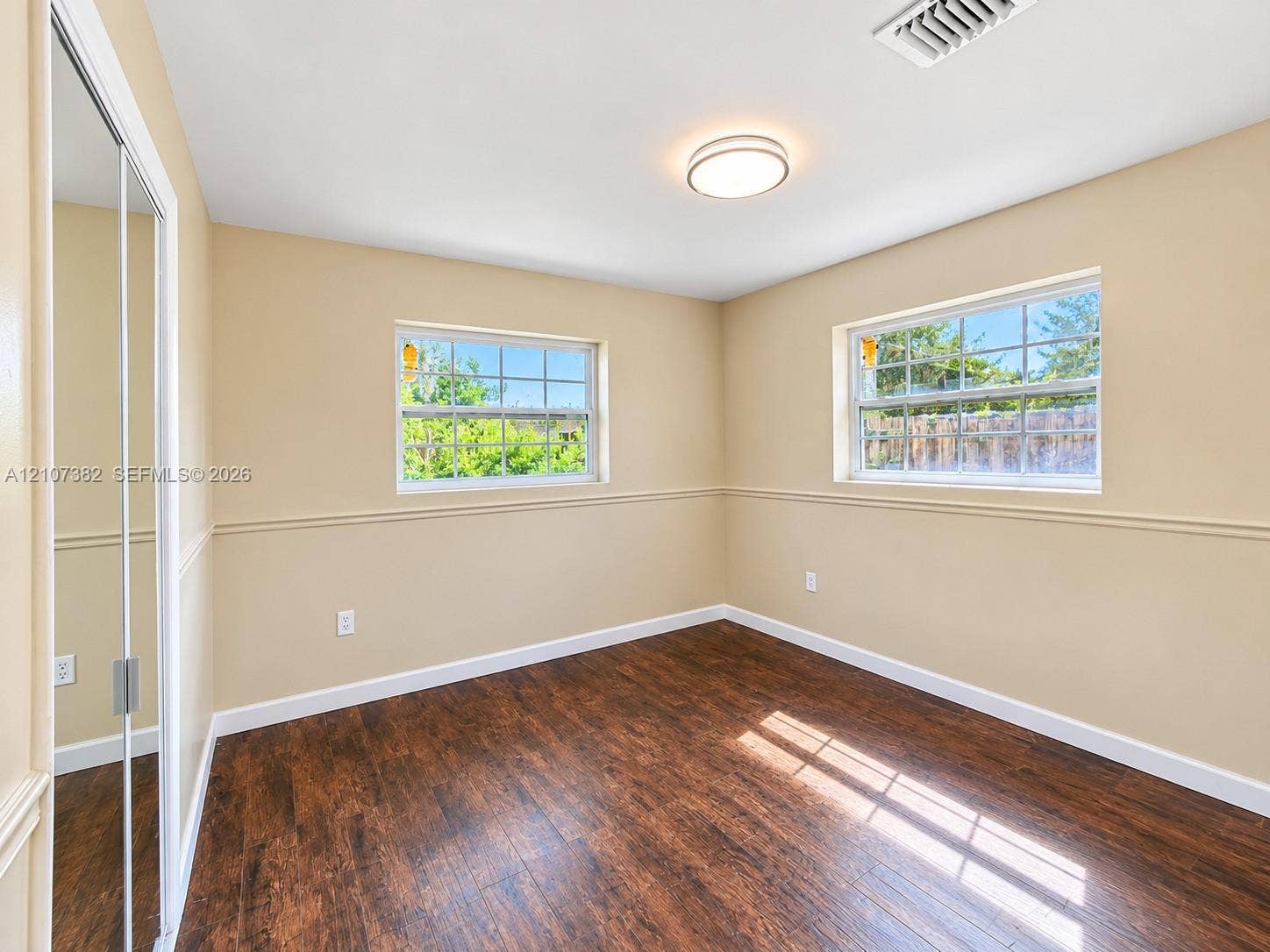 859 Caroline Circle, Palm Beach, FL 33413 Wood-finish flooring, mirrored sliding closet doors, chair rail molding, and dual grid-pane windows