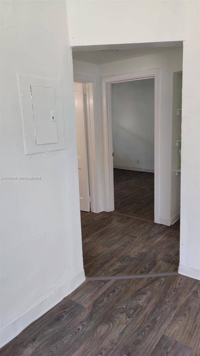 Interior space with neutral wall paint and wood-finish flooring