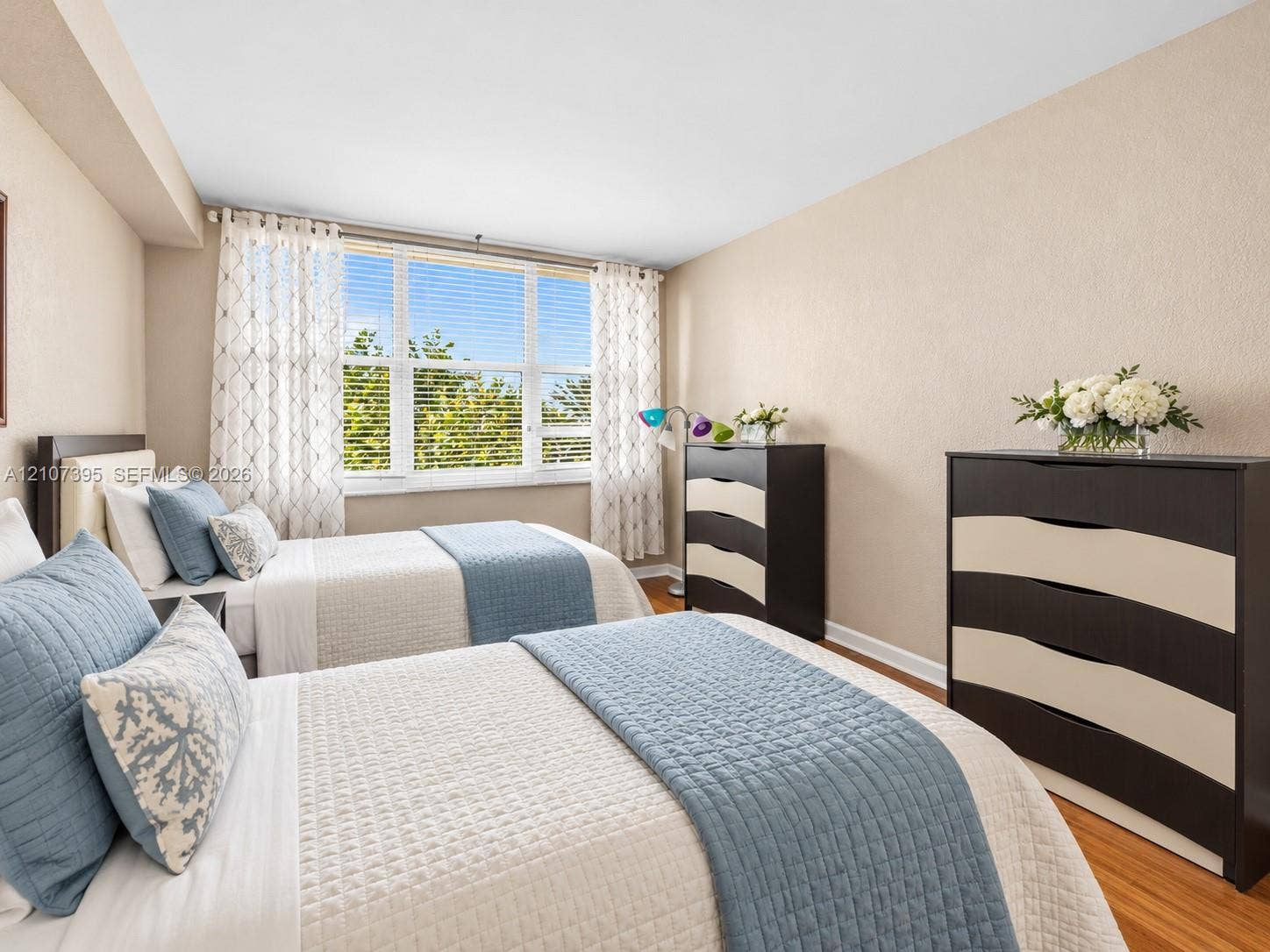 Neutral-toned walls, large multi-pane windows, and wood-finish flooring