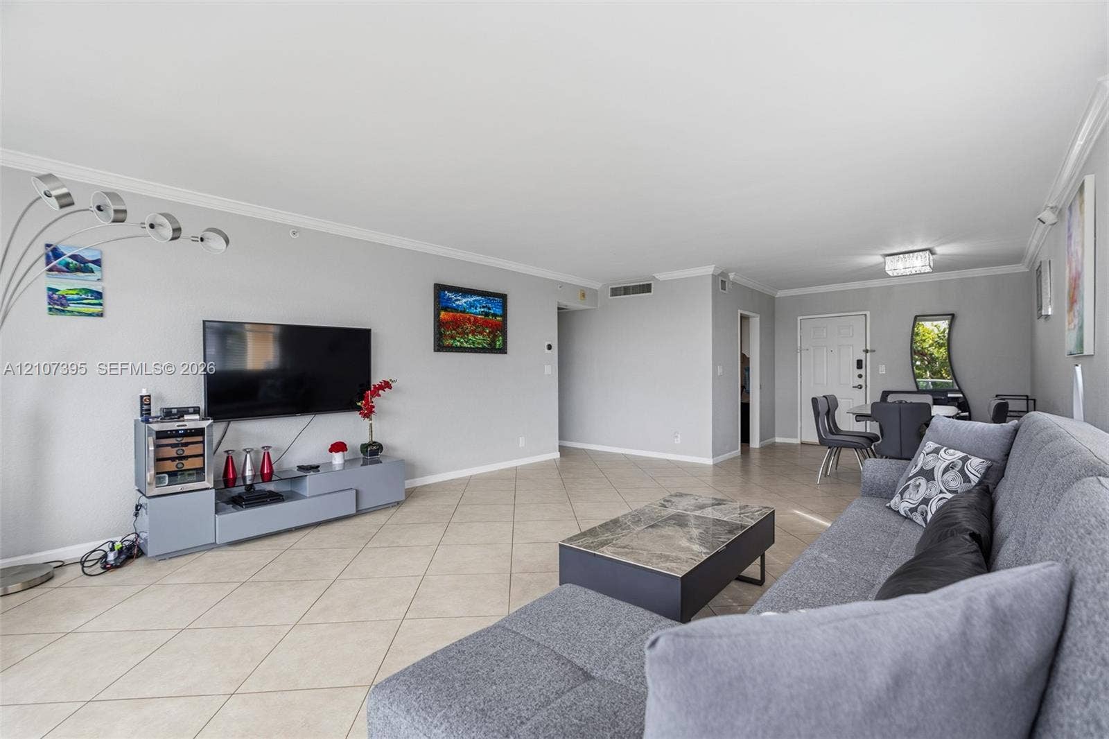 Neutral-toned interior featuring large-format diagonal tile flooring, crown molding, and recessed lighting