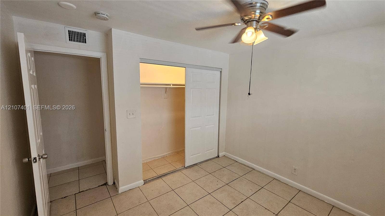 1524 SW 5th Place, #C, Fort Lauderdale, Fort Lauderdale, FL 33312 Interior space featuring light-colored floor tiling, a closet with sliding paneled doors, and a ceiling-mounted light fixture with a fan