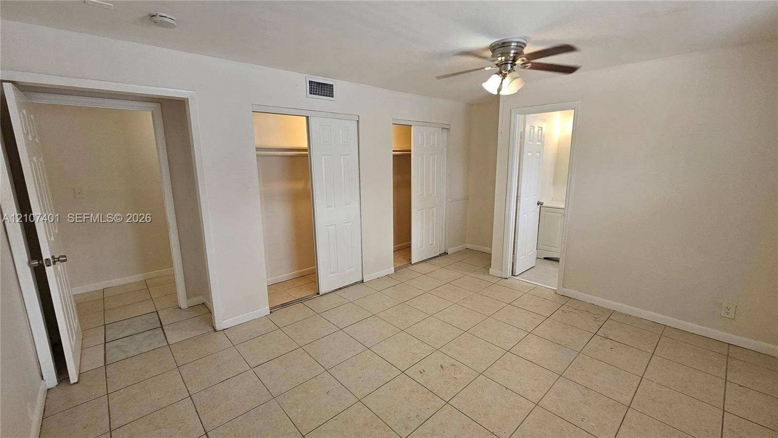 1524 SW 5th Place, #C, Fort Lauderdale, Fort Lauderdale, FL 33312 Tile flooring, ceiling fan with integrated lighting, and dual reach-in closets featuring multi-panel doors