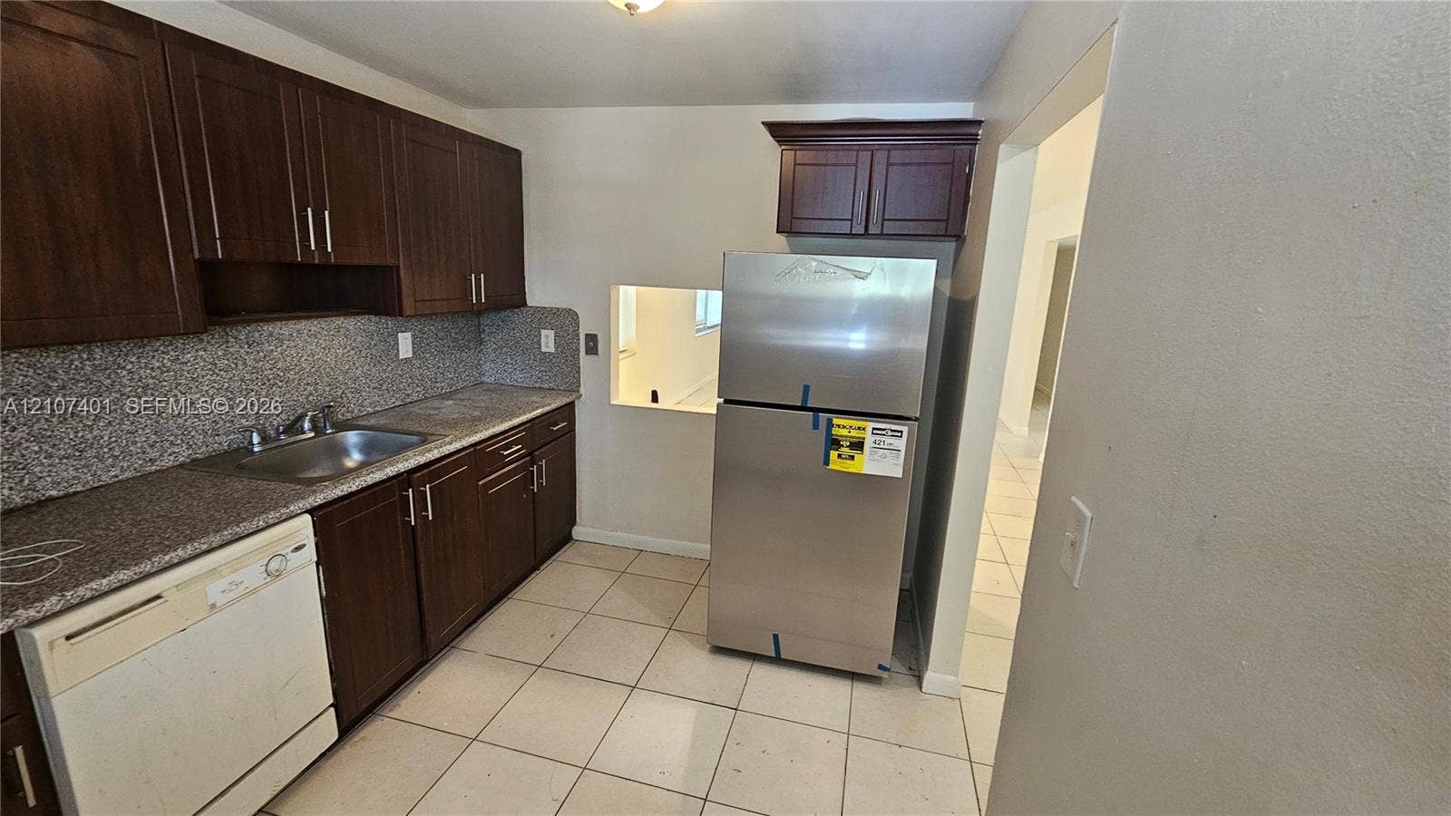 1524 SW 5th Place, #C, Fort Lauderdale, Fort Lauderdale, FL 33312 Kitchen featuring dark-stained wooden cabinetry, stone-finish countertops, stainless steel refrigerator, and tiled flooring