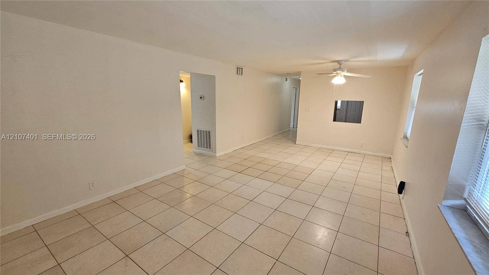 1524 SW 5th Place, #C, Fort Lauderdale, Fort Lauderdale, FL 33312 Interior room featuring neutral-toned tile flooring, recessed wall opening, and a ceiling-mounted light fixture
