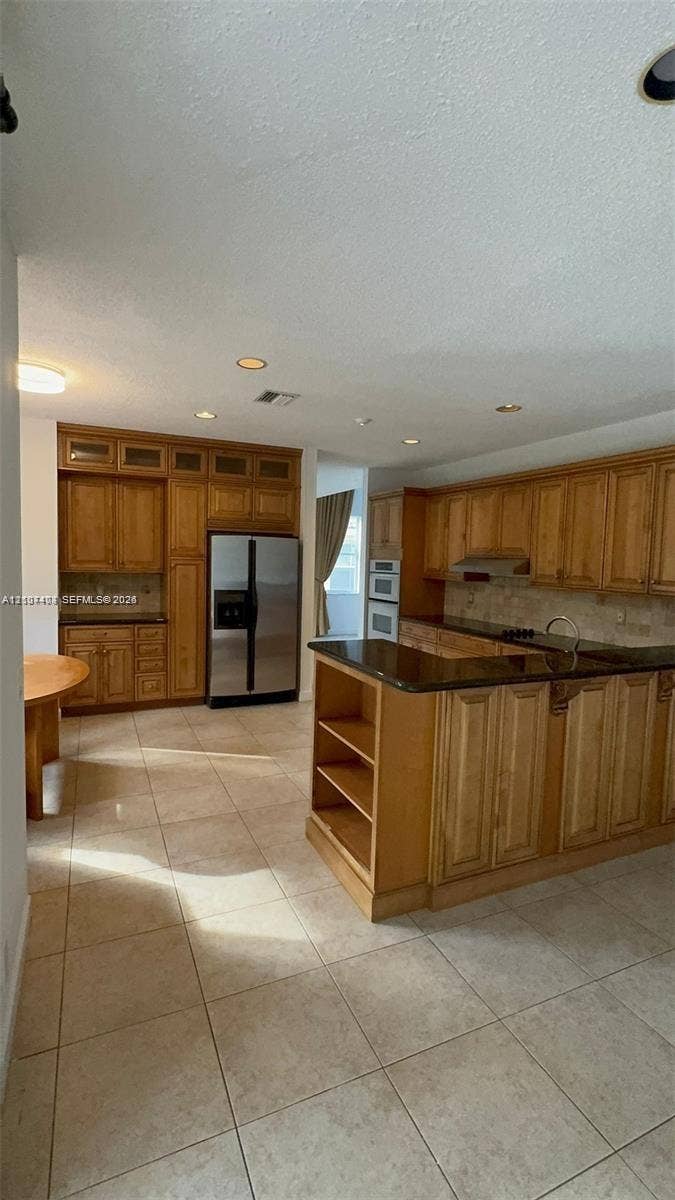 1559 Elm Grove Road, Weston, Weston, FL 33327 Kitchen featuring extensive wood cabinetry, dark stone countertops, tile flooring, recessed lighting, and built-in appliances