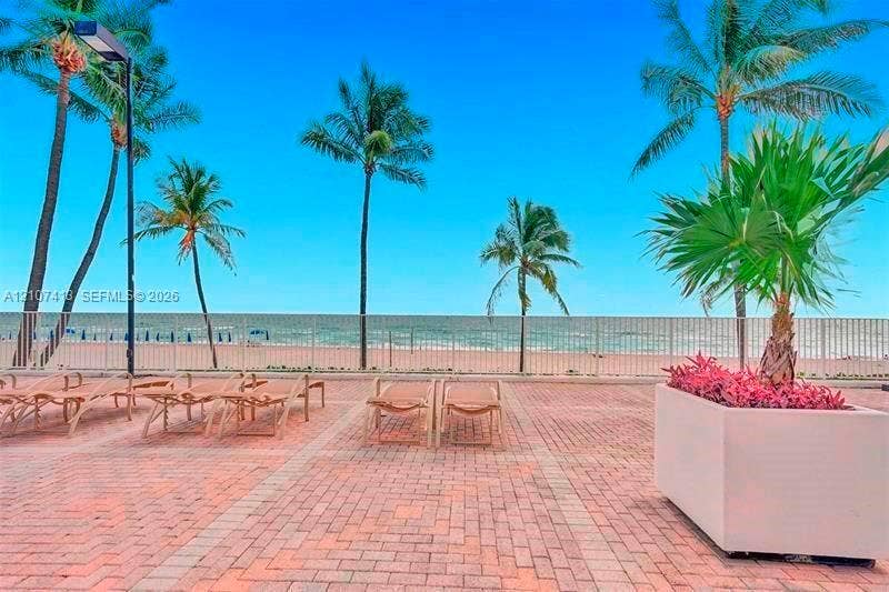 2301 S Ocean Drive, #1606, Hollywood, Hollywood, FL 33019 Outdoor terrace featuring brick paver flooring, perimeter metal fencing, and integrated planter boxes with lush landscaping