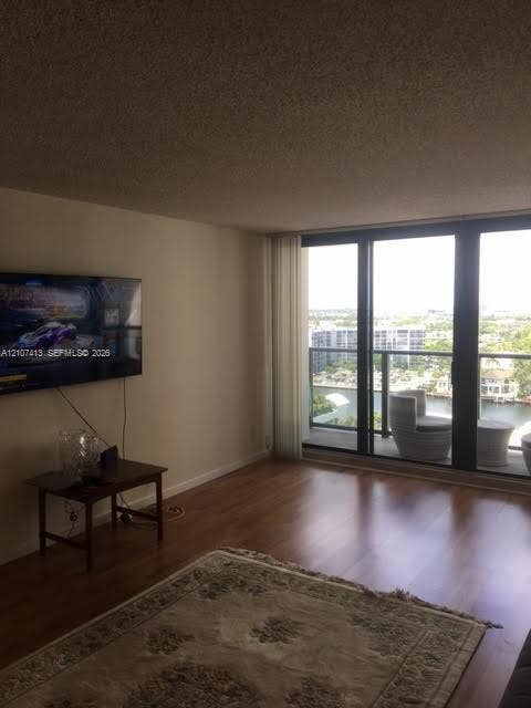 2301 S Ocean Drive, #1606, Hollywood, Hollywood, FL 33019 Living area featuring wood-finish flooring and floor-to-ceiling sliding glass doors providing access to a private balcony