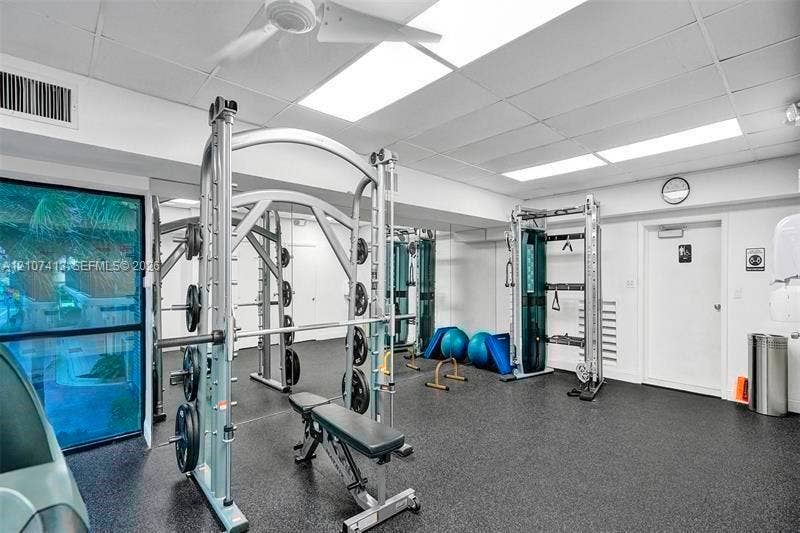 2301 S Ocean Drive, #1606, Hollywood, Hollywood, FL 33019 Exercise room featuring rubber flooring, recessed drop ceiling lighting, and floor-to-ceiling mirrored walls