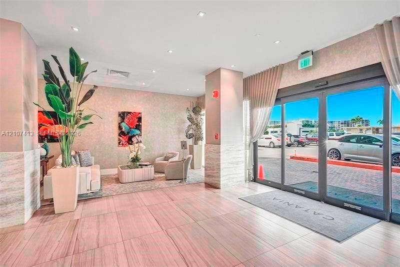 2301 S Ocean Drive, #1606, Hollywood, Hollywood, FL 33019 Lobby entrance featuring large-format tile flooring, stone-accented columns, floor-to-ceiling glass sliding doors, and recessed ceiling lighting