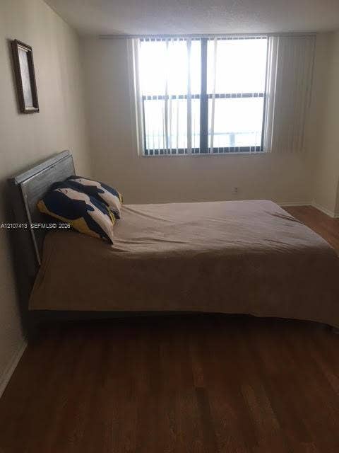 2301 S Ocean Drive, #1606, Hollywood, Hollywood, FL 33019 Room featuring wood-finish flooring and a large window with vertical blinds