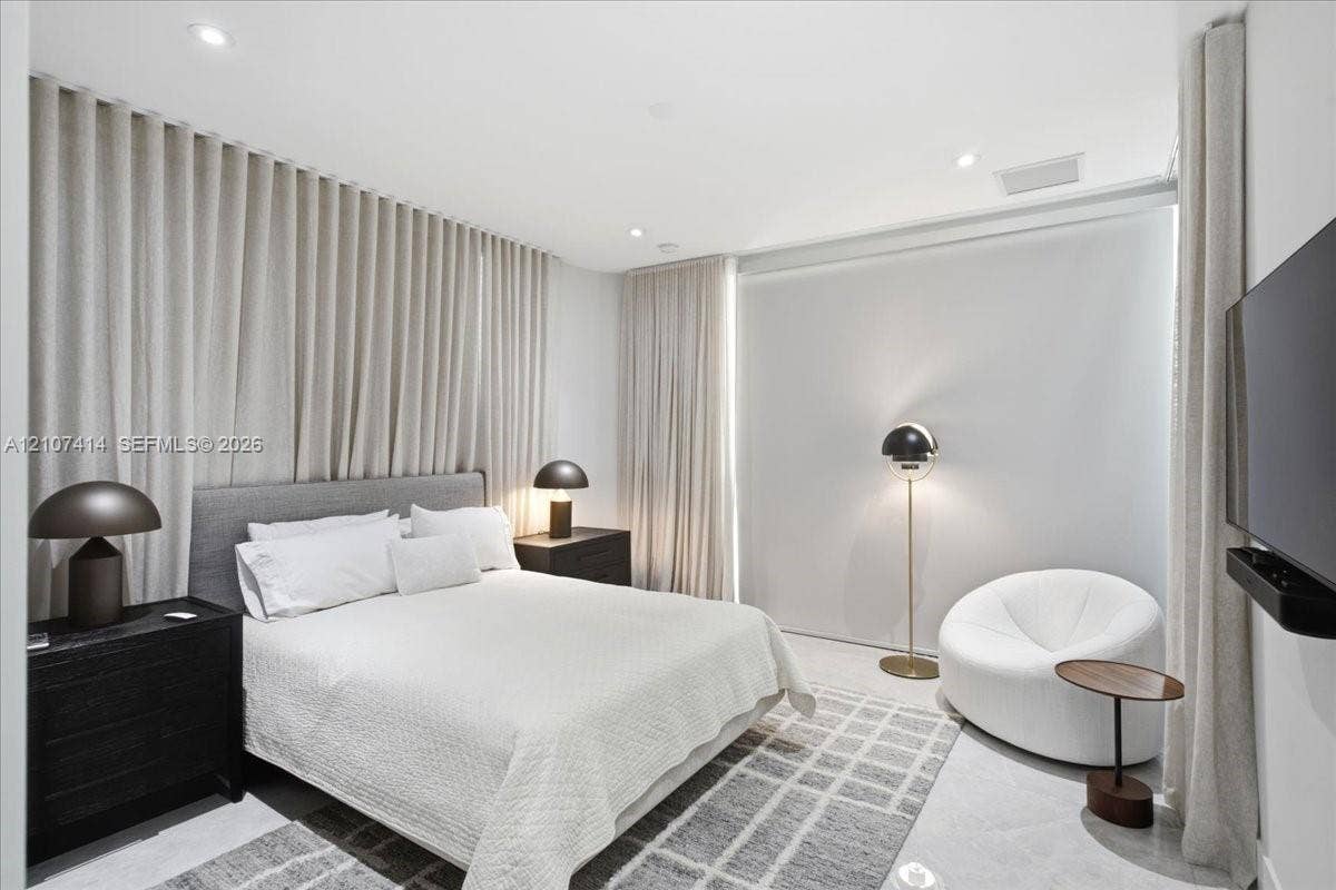 Wall-to-wall floor-to-ceiling drapery, recessed ceiling lighting, and smooth surface flooring