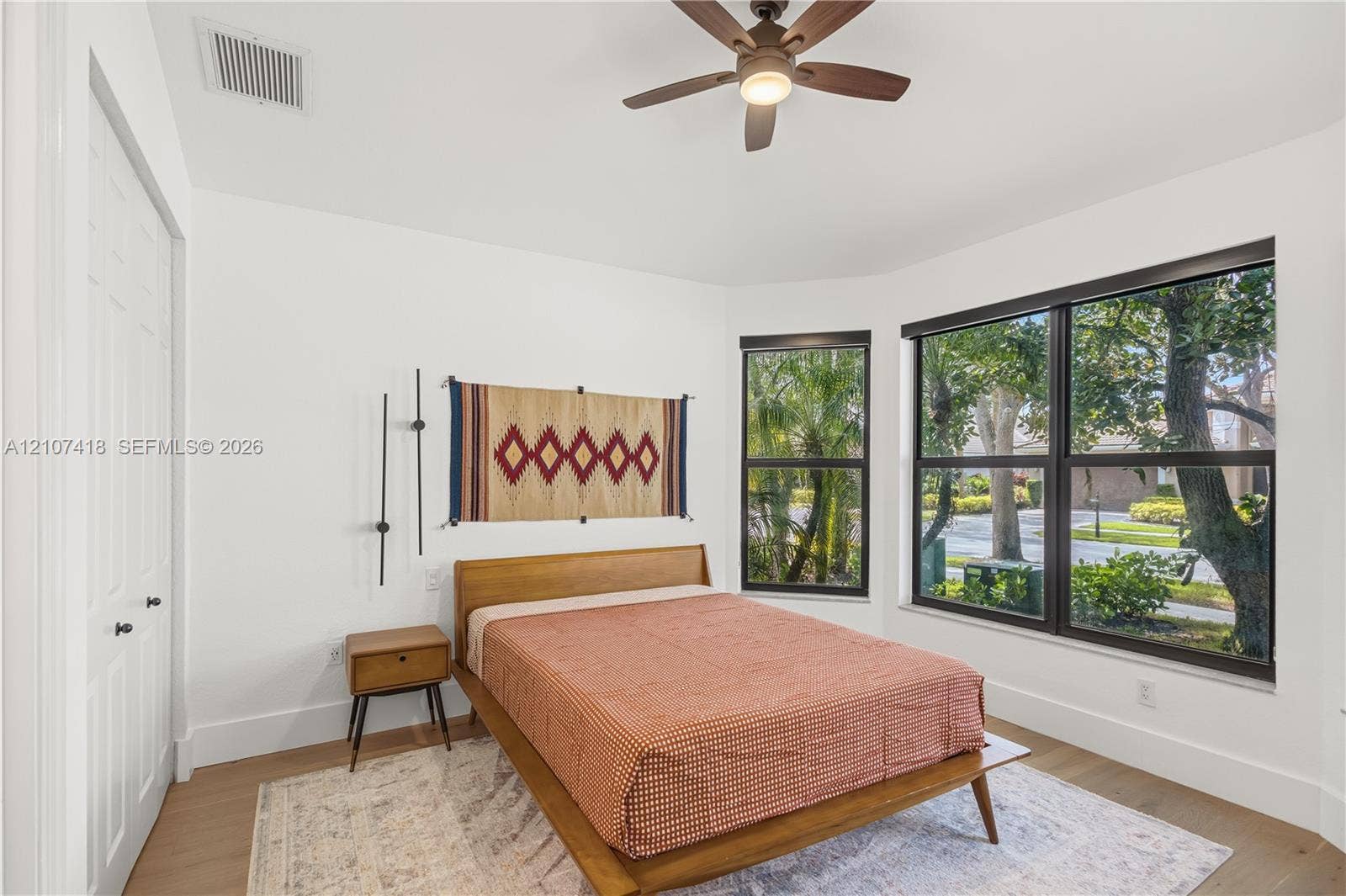 19305 Skyridge Circle, #n/a, Boca Raton, Boca Raton, FL 33498 Room featuring wood-finish flooring, a ceiling fan with integrated lighting, and large windows with dark-finish frames