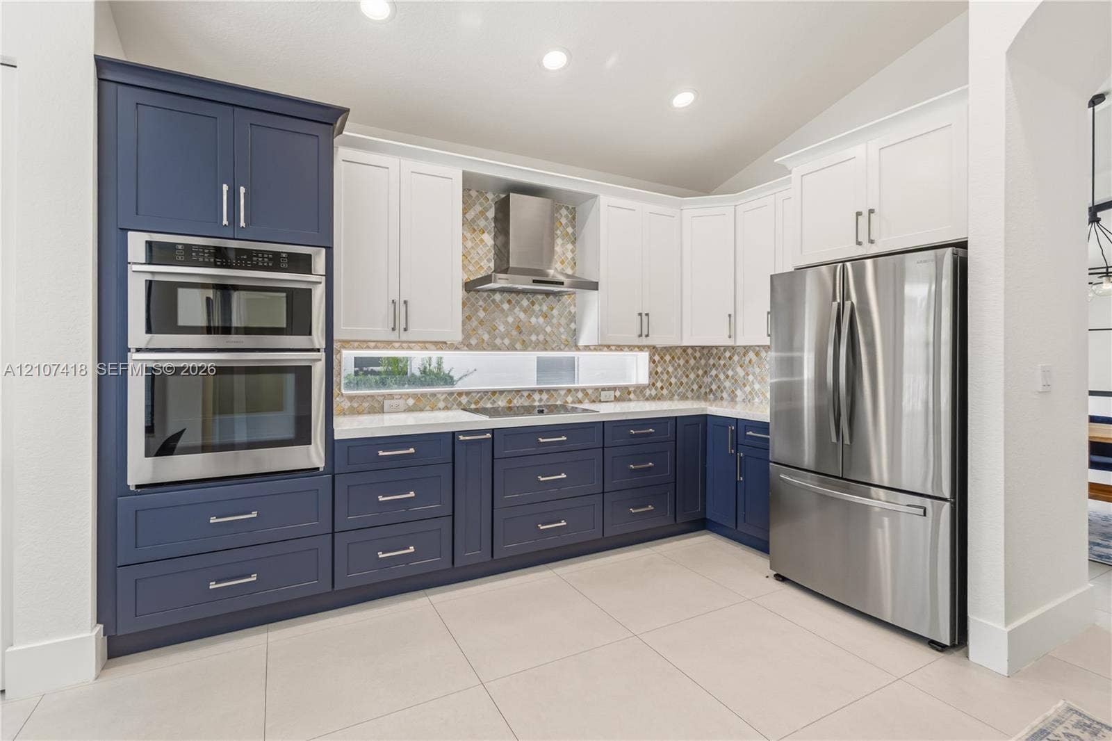 19305 Skyridge Circle, #n/a, Boca Raton, Boca Raton, FL 33498 Kitchen featuring two-tone cabinetry, stainless steel double wall oven, stainless steel refrigerator, patterned mosaic tile backsplash, and quartz countertops