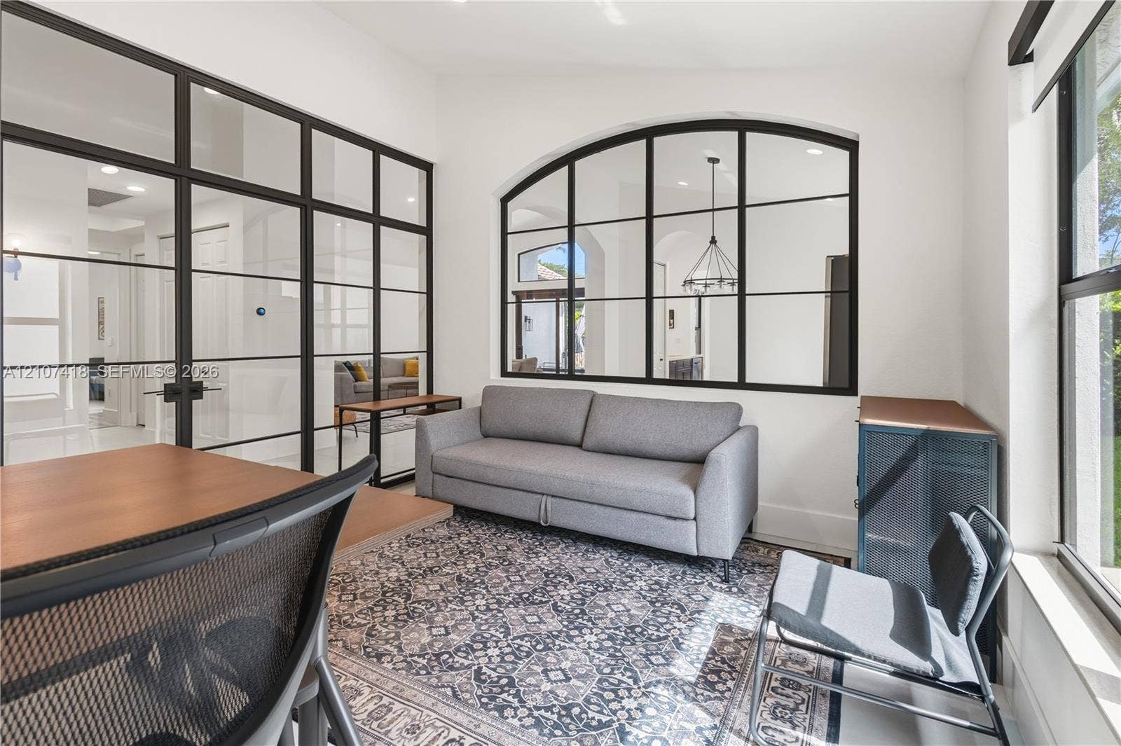 19305 Skyridge Circle, #n/a, Boca Raton, Boca Raton, FL 33498 Interior space featuring floor-to-ceiling metal-framed glass partitions and a large arched metal-framed glass window