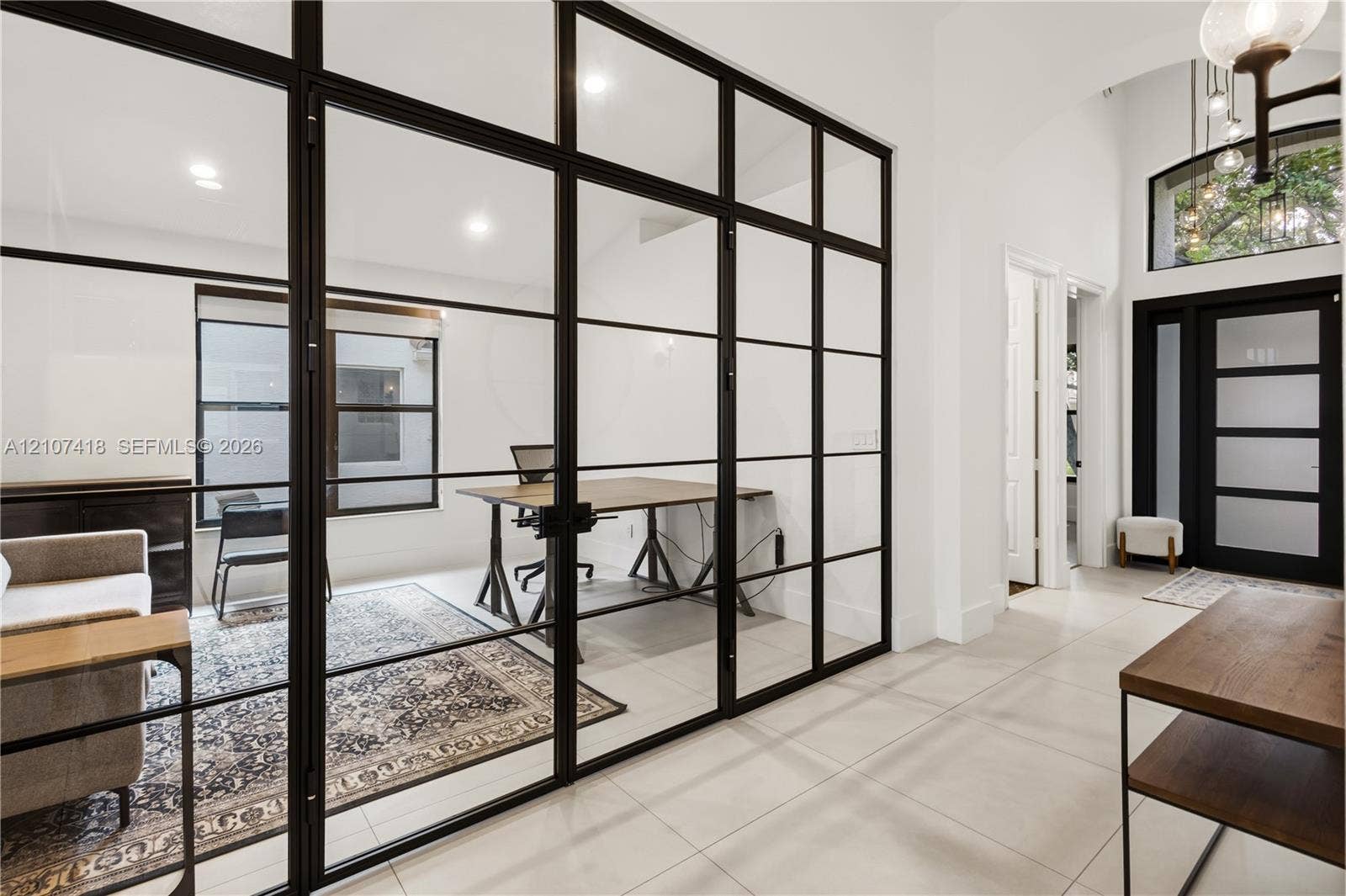 19305 Skyridge Circle, #n/a, Boca Raton, Boca Raton, FL 33498 Floor-to-ceiling iron-frame glass room divider, recessed lighting, tile flooring, arched entryway, and front door with glass inserts
