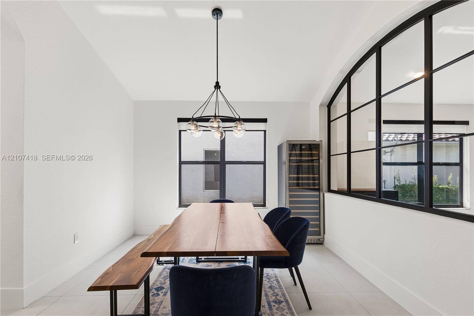 19305 Skyridge Circle, #n/a, Boca Raton, Boca Raton, FL 33498 Black metal-framed glass partition, modern multi-globe chandelier, built-in wine refrigerator, and tile flooring