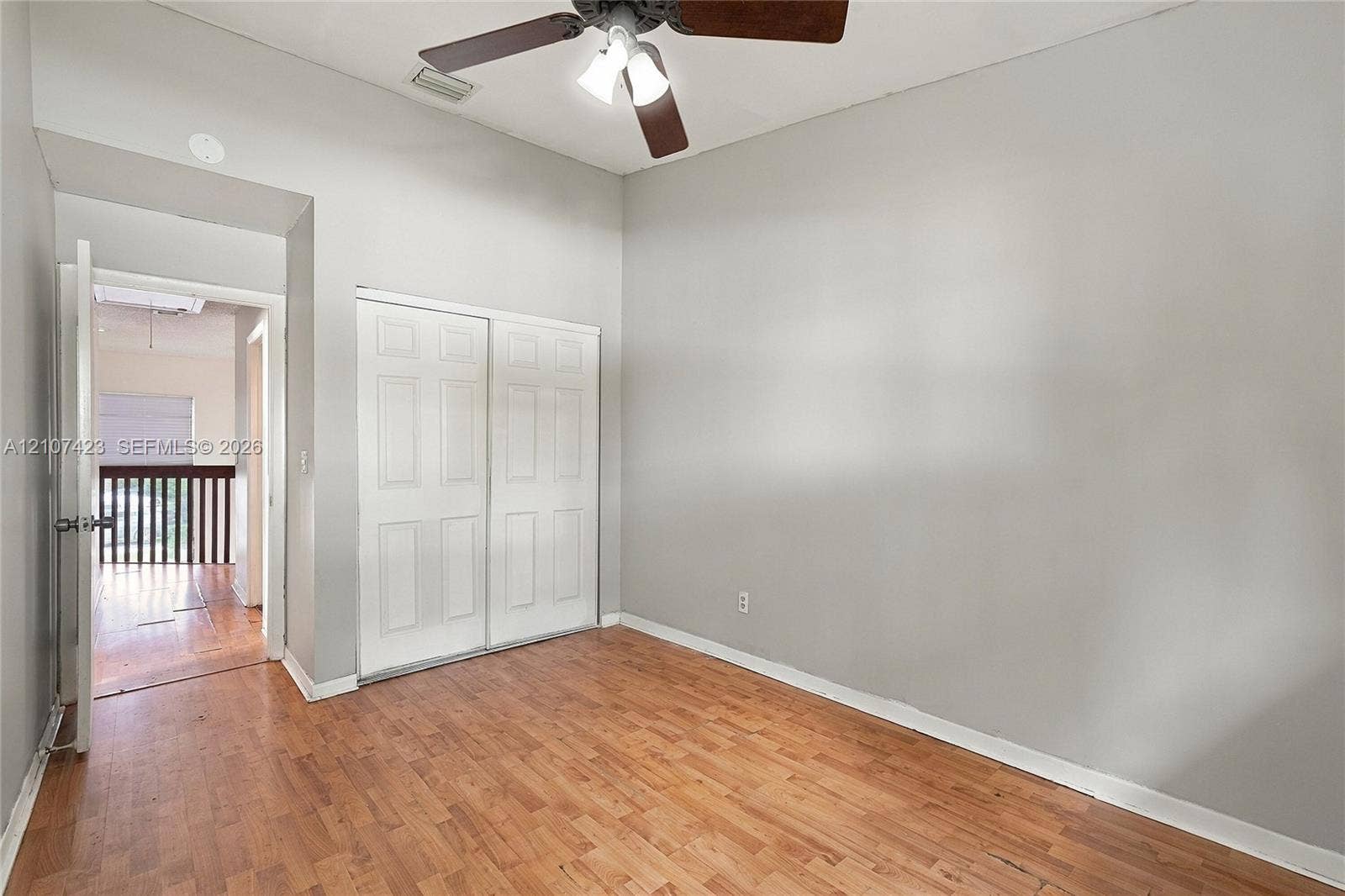 650 NE 195th Street, Miami, FL 33179 Vaulted ceilings, wood-finish flooring, and a ceiling fan with integrated lighting