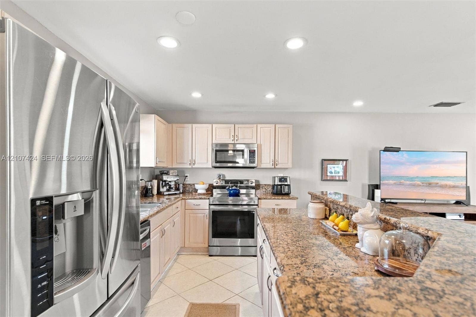 14702 Vista Luna Drive, Davie, FL 33325 Kitchen featuring stone-finish countertops, stainless steel refrigerator, built-in microwave, range, and recessed lighting
