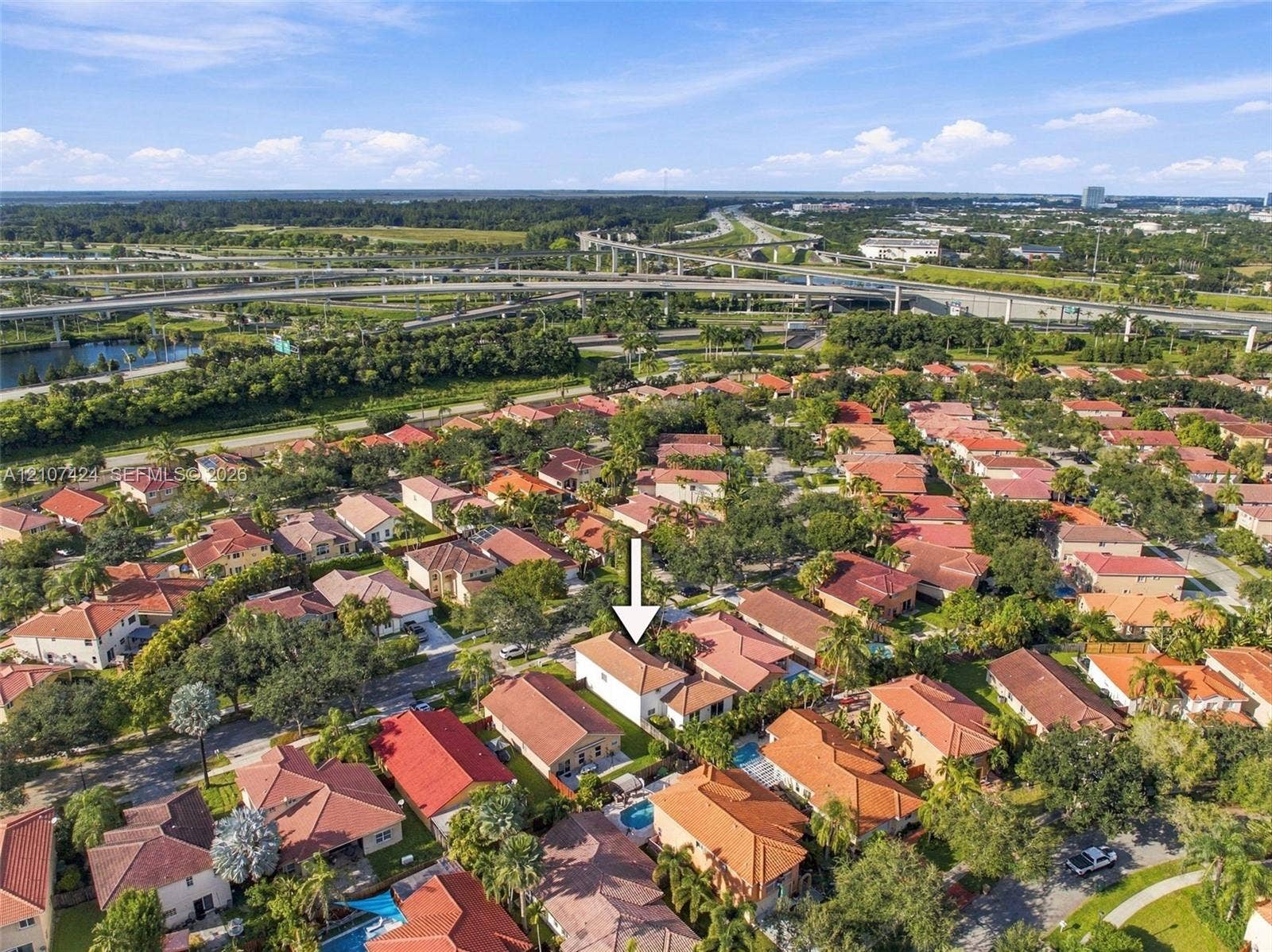 14702 Vista Luna Drive, Davie, FL 33325 Aerial perspective of a single-story residence featuring a tile roof and a private swimming pool