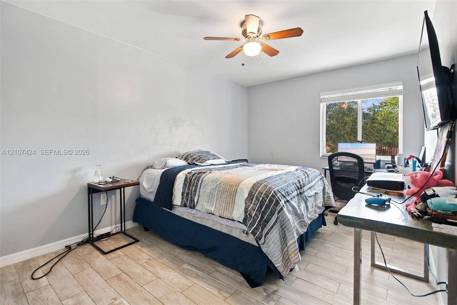 14702 Vista Luna Drive, Davie, FL 33325 Room featuring wood-finish tile flooring, ceiling fan with light fixture, and single-pane window
