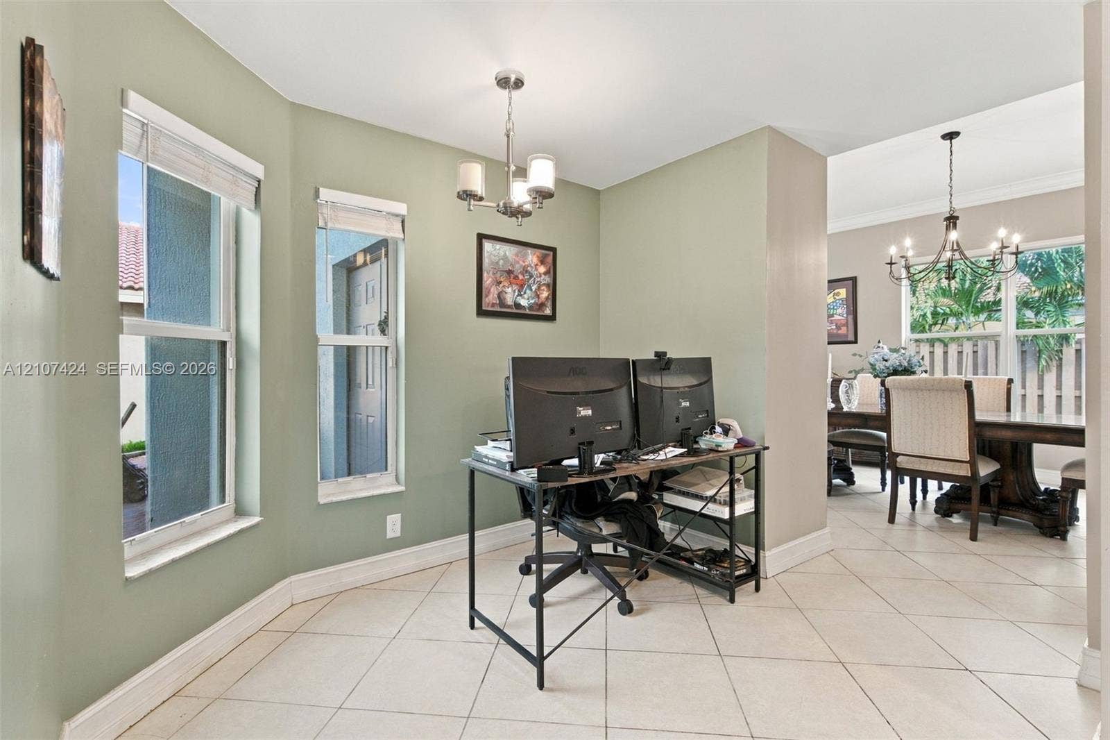 14702 Vista Luna Drive, Davie, FL 33325 Bay window featuring multi-pane windows, large-format neutral tile flooring, and decorative chandeliers