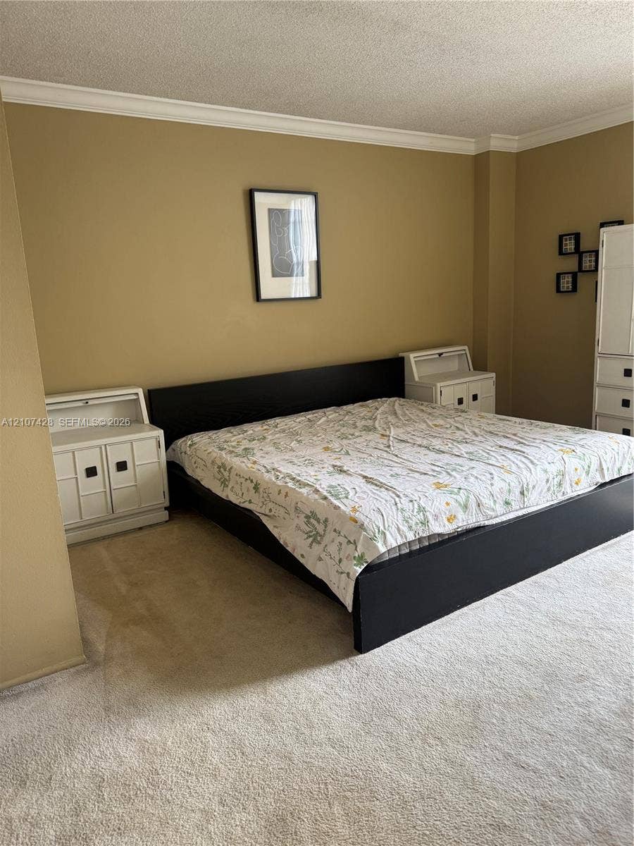 3475 N Country Club Drive, #704, Aventura, Aventura, FL 33180 Interior room featuring neutral wall paint, wall-to-wall carpeting, and crown molding